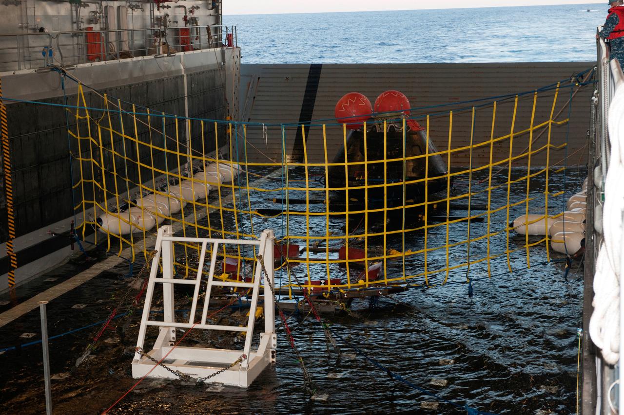 NASA’s Orion spacecraft is pulled safely into the well deck of the U.S. Navy’s USS Anchorage, following its splashdown in the Pacific Ocean. Orion launched into space on a two-orbit, 4.5-test flight at 7:05 am EST on Dec. 5, and returned safely to Earth, where a combined team from NASA, the Navy and Orion prime contractor Lockheed Martin retrieved it for return to shore. It's now being transported back to shore on board the Anchorage. It is expected to be off loaded at Naval Base San Diego on Monday. Part of Batch image transfer from Flickr.