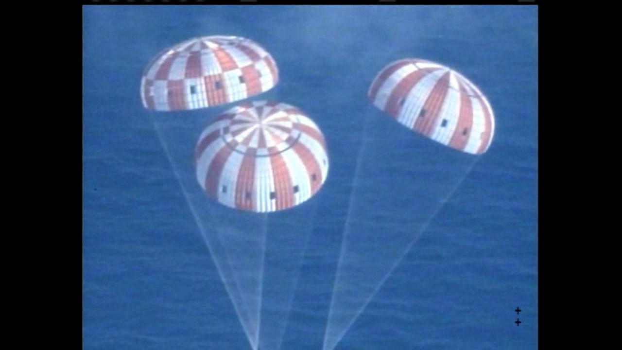 Following more than four hours in Earth orbit, NASA's Orion spacecraft is seen from an unpiloted aircraft as it descends under three massive red and white main parachutes after Exploration Flight Test-1 (EFT-1) on Dec. 5, 2014. Splashdown in the Pacific Ocean will take place at less than 20 mph. It will be recovered by the USS Anchorage, a landing platform-dock, or LPD, ship.   Part of Batch image transfer from Flickr.