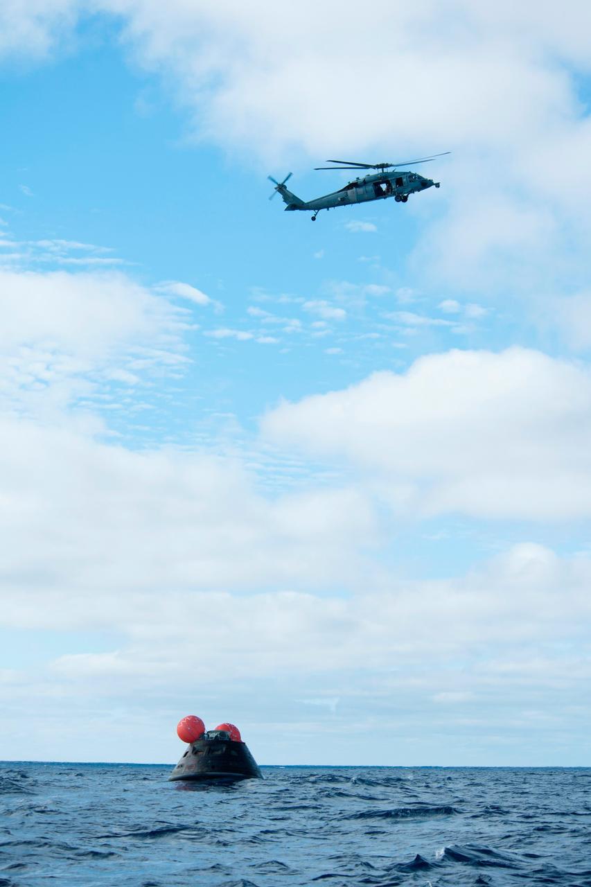 NASA's Orion spacecraft awaits the U.S. Navy's USS Anchorage for a ride home. Orion launched into space on a two-orbit, 4.5-test flight at 7:05 am EST on Dec. 5, and returned safely splashed down in the Pacific Ocean, where a combined team from NASA, the Navy and Orion prime contractor Lockheed Martin retrieved it for return to shore. It's now being transported back to shore on board the Anchorage. It is expected to be off loaded at Naval Base San Diego on Monday.  Part of Batch image transfer from Flickr.