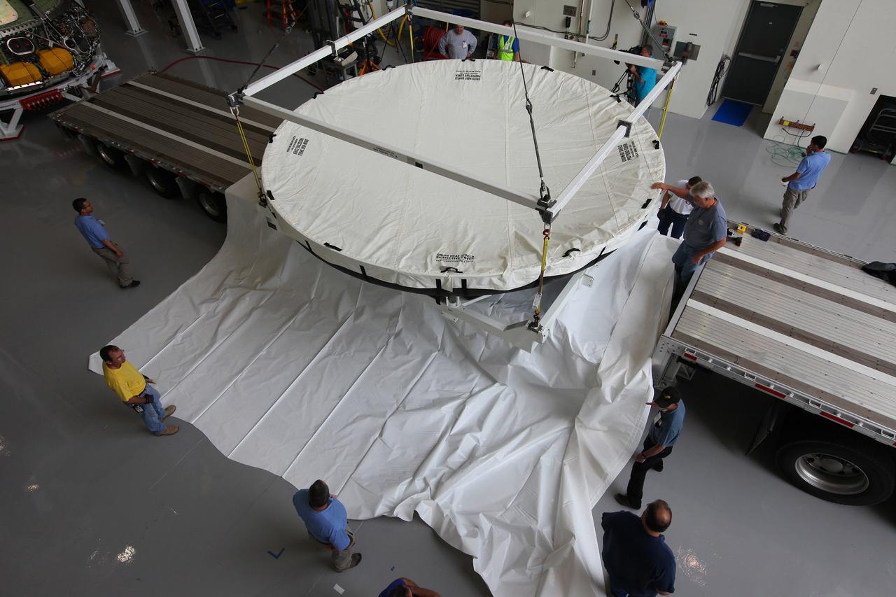 Engineers at Kennedy Space Center prepare the Orion heat shield for transport to Marshall Space Flight Center for testing on March 2, 2015. The heat shield flew on Orion's Exploration Flight Test-1 (EFT-1) in December 2014, protecting the spacecraft from 4000 degree F temperatures during reentry.  Part of Batch image transfer from Flickr.