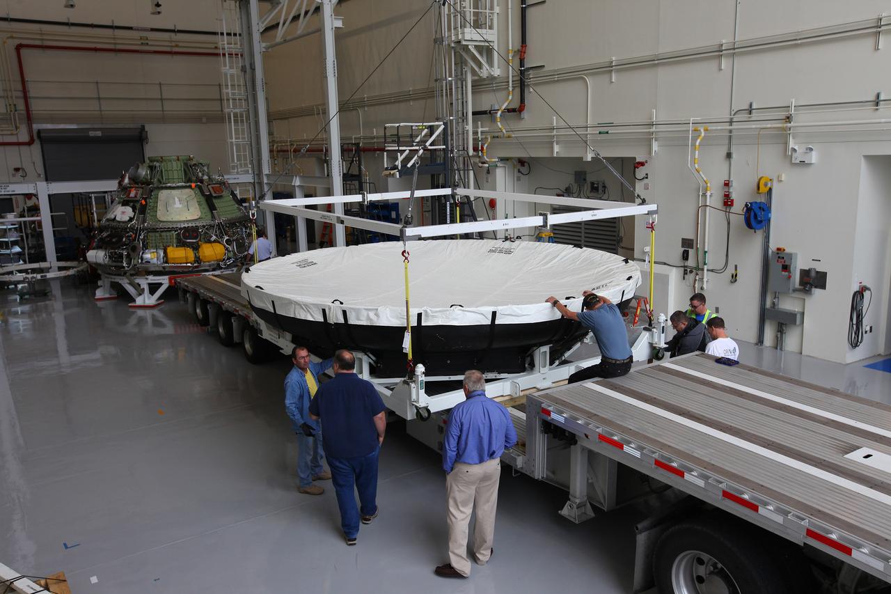 Engineers at Kennedy Space Center prepare the Orion heat shield for transport to Marshall Space Flight Center for testing on March 2, 2015. The heat shield flew on Orion's Exploration Flight Test-1 (EFT-1) in December 2014, protecting the spacecraft from 4000 degree F temperatures during reentry.  Part of Batch image transfer from Flickr.