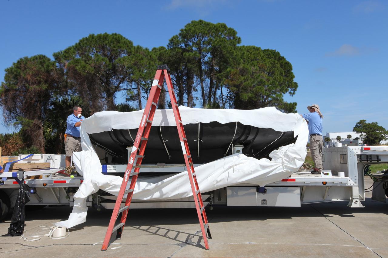 Engineers at Kennedy Space Center prepare the Orion heat shield for transport to Marshall Space Flight Center for testing on March 2, 2015. The heat shield flew on Orion's Exploration Flight Test-1 (EFT-1) in December 2014, protecting the spacecraft from 4000 degree F temperatures during reentry.  Part of Batch image transfer from Flickr.