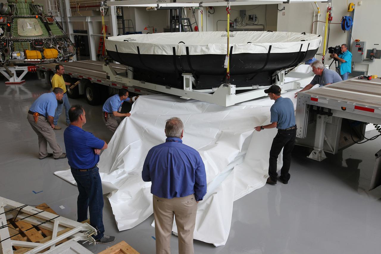 Engineers at Kennedy Space Center prepare the Orion heat shield for transport to Marshall Space Flight Center for testing on March 2, 2015. The heat shield flew on Orion's Exploration Flight Test-1 (EFT-1) in December 2014, protecting the spacecraft from 4000 degree F temperatures during reentry.  Part of Batch image transfer from Flickr.