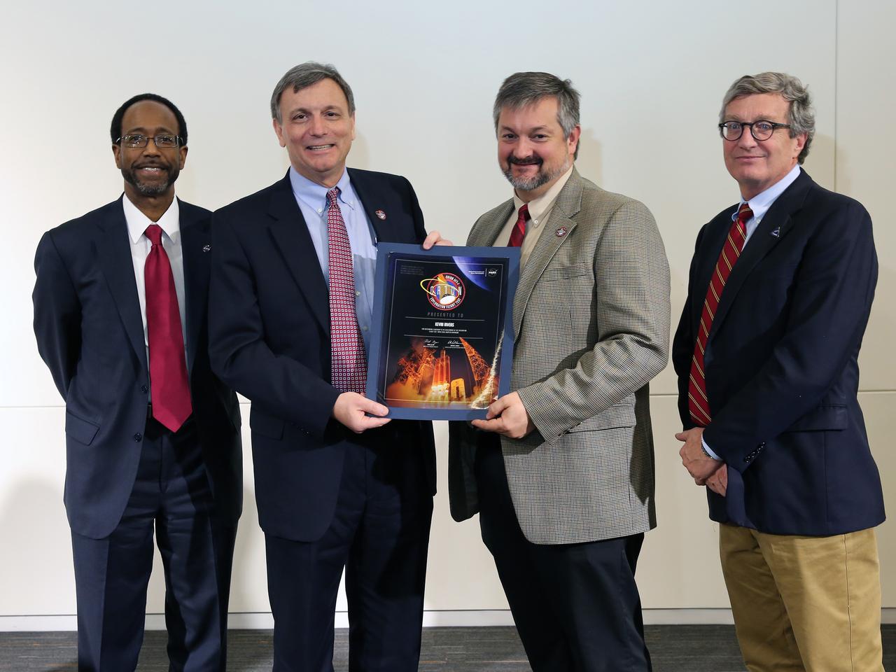NASA and Lockheed Martin Orion leadership visit Langley Research Center in Hampton, VA on March 19, 2015 to celebrate the center's contribution to Orion's Exploration Flight Test-1 (EFT-1). Award is presented to Kevin Rivers. Part of Batch image transfer from Flickr.