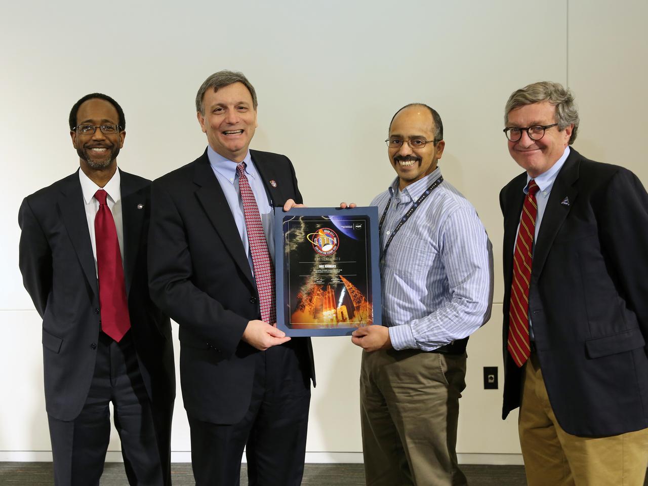 NASA and Lockheed Martin Orion leadership visit Langley Research Center in Hampton, VA on March 19, 2015 to celebrate the center's contribution to Orion's Exploration Flight Test-1 (EFT-1). Award presented to Mike Rodriguez. Part of Batch image transfer from Flickr.