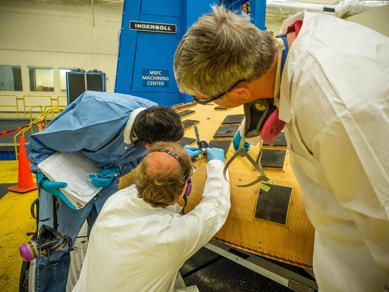 Engineers from NASA's Ames Research Center at Moffett Field, California, and Marshall Space Flight Center in Huntsville, Alabama, remove samples on May 4, 2015, from Orion's heat shield which flew on Exploration Flight Test-1 (EFT-1) in 2014. The heat shield protected the spacecraft from temperatures reaching 4000 degrees F. Part of Batch image transfer from Flickr.