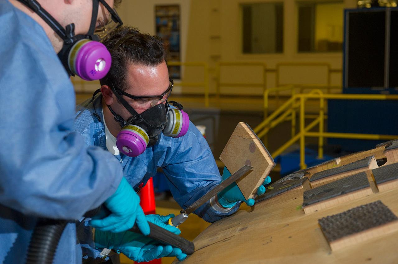 Engineers from NASA's Ames Research Center at Moffett Field, California, and Marshall Space Flight Center in Huntsville, Alabama, remove samples on May 4, 2015, from Orion's heat shield which flew on Exploration Flight Test-1 (EFT-1) in 2014. The heat shield protected the spacecraft from temperatures reaching 4000 degrees F. Part of Batch image transfer from Flickr.