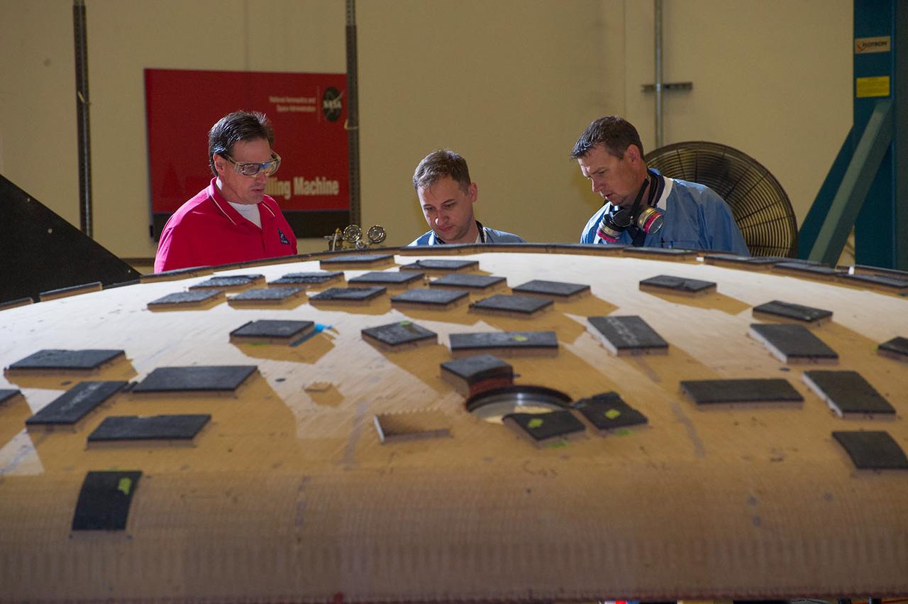 Engineers from NASA's Ames Research Center at Moffett Field, California, and Marshall Space Flight Center in Huntsville, Alabama, remove samples on May 4, 2015, from Orion's heat shield which flew on Exploration Flight Test-1 (EFT-1) in 2014. The heat shield protected the spacecraft from temperatures reaching 4000 degrees F. Part of Batch image transfer from Flickr.