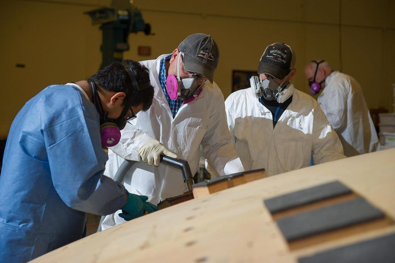 Engineers from NASA's Ames Research Center at Moffett Field, California, and Marshall Space Flight Center in Huntsville, Alabama, remove samples on May 4, 2015, from Orion's heat shield which flew on Exploration Flight Test-1 (EFT-1) in 2014. The heat shield protected the spacecraft from temperatures reaching 4000 degrees F. Part of Batch image transfer from Flickr.