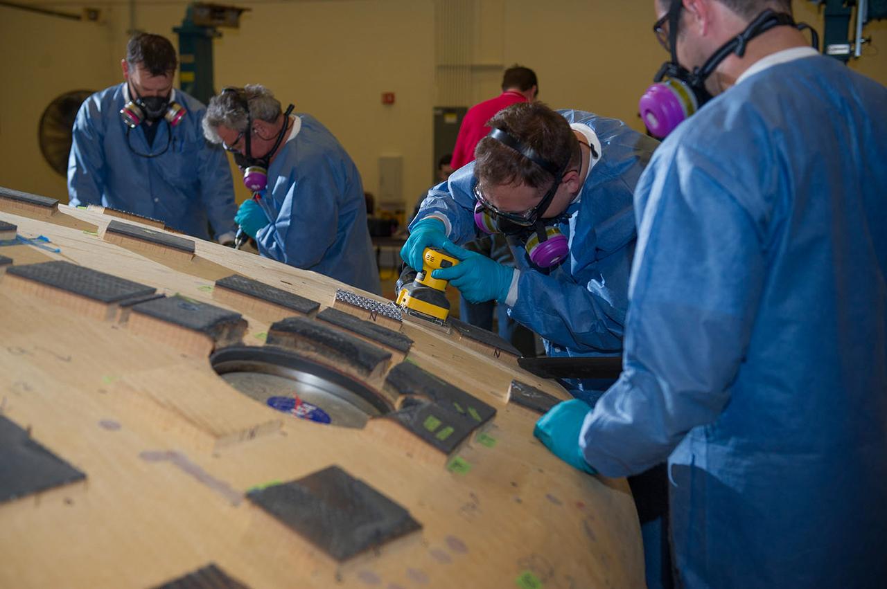Engineers from NASA's Ames Research Center at Moffett Field, California, and Marshall Space Flight Center in Huntsville, Alabama, remove samples on May 4, 2015, from Orion's heat shield which flew on Exploration Flight Test-1 (EFT-1) in 2014. The heat shield protected the spacecraft from temperatures reaching 4000 degrees F. Part of Batch image transfer from Flickr.