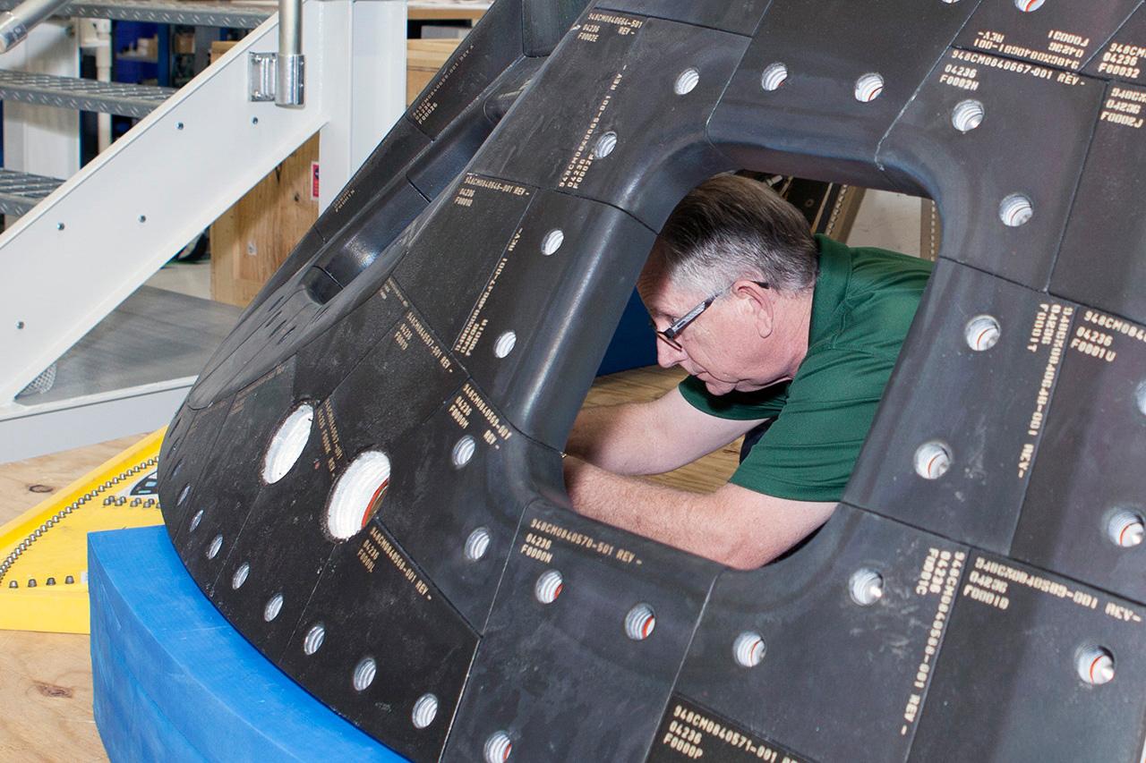 Inside the Neil Armstrong Operations and Checkout Building high bay at NASA's Kennedy Space Center in Florida, technicians remove a side thermal window from one of Orion's tile panels on May 15, 2015. The tile panels with thermal windows intact were removed from Orion in the Launch Abort System Facility after the Exploration Flight Test-1 (EFT-1) spacecraft returned to Kennedy in late December. All of the windows are being removed and disassembled for post-flight inspection for any signs of micrometeoroid or orbital debris impacts or other potential glass damage. Part of Batch image transfer from Flickr.
