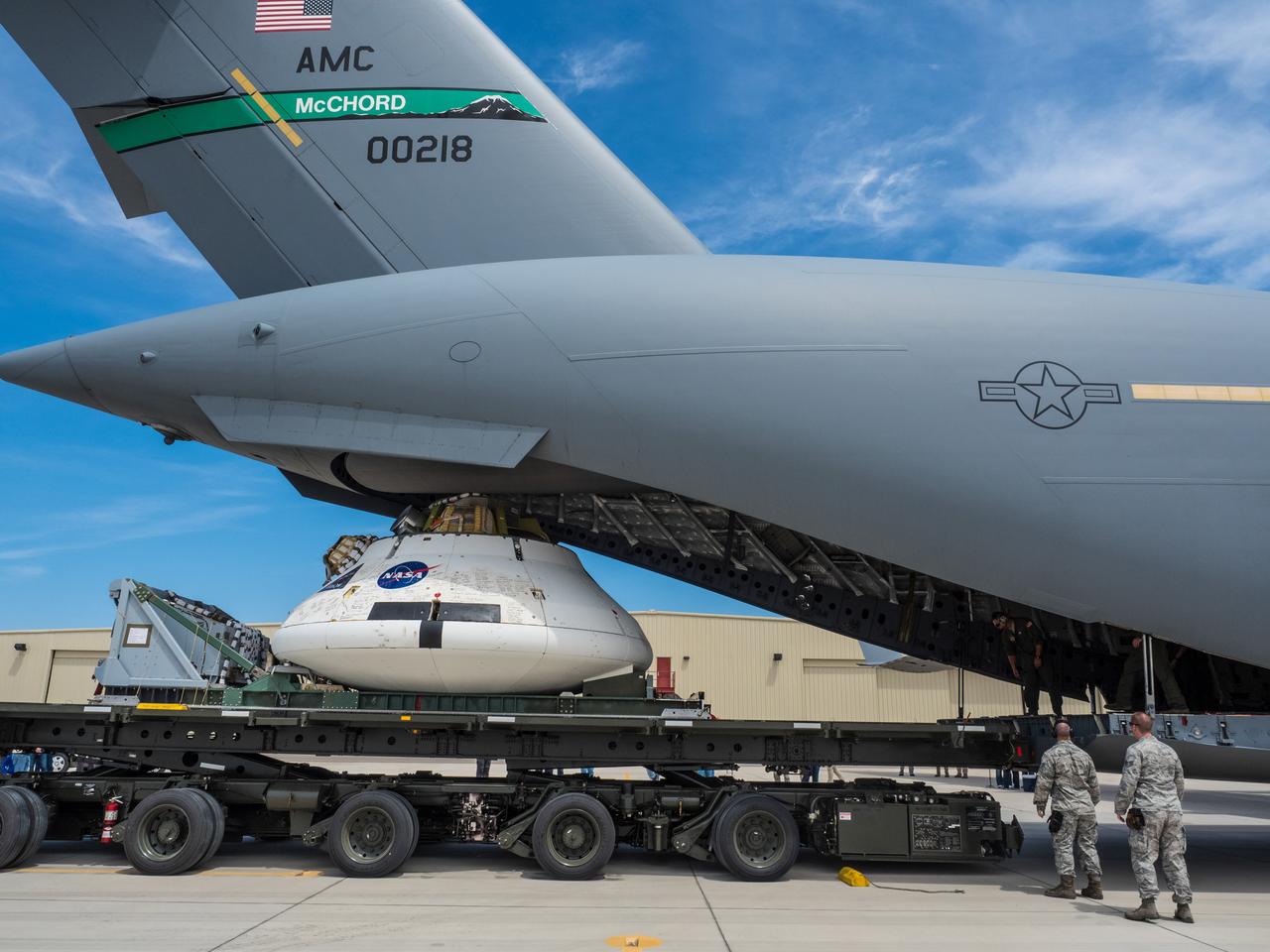 Engineers prepare to test the parachute system for NASA’s Orion spacecraft at the U.S. Army Yuma Proving Ground in Yuma, Arizona on Aug. 24, 2015. During the test, planned for Wednesday, Aug. 26, a C-17 aircraft will carry a representative Orion capsule to 35,000 feet in altitude and then drop it from its cargo bay. Engineers will test a scenario in which one of Orion’s two drogue parachutes, used to stabilize it in the air, does not deploy, and one of its three main parachutes, used to slow the capsule during the final stage of descent, also does not deploy. The risky test will provide data engineers will use as they gear up to qualify Orion’s parachutes for missions with astronauts. On Aug. 24, a C-17 was loaded with the test version of Orion, which has a similar mass and interfaces with the parachutes as the Orion being developed for deep space missions but is shorter on top to fit inside the aircraft. Part of Batch image transfer from Flickr.