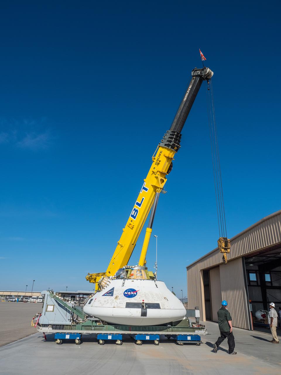 Engineers prepare to test the parachute system for NASA’s Orion spacecraft at the U.S. Army Yuma Proving Ground in Yuma, Arizona on Aug. 24, 2015. During the test, planned for Wednesday, Aug. 26, a C-17 aircraft will carry a representative Orion capsule to 35,000 feet in altitude and then drop it from its cargo bay. Engineers will test a scenario in which one of Orion’s two drogue parachutes, used to stabilize it in the air, does not deploy, and one of its three main parachutes, used to slow the capsule during the final stage of descent, also does not deploy. The risky test will provide data engineers will use as they gear up to qualify Orion’s parachutes for missions with astronauts. On Aug. 24, a C-17 was loaded with the test version of Orion, which has a similar mass and interfaces with the parachutes as the Orion being developed for deep space missions but is shorter on top to fit inside the aircraft. Part of Batch image transfer from Flickr.