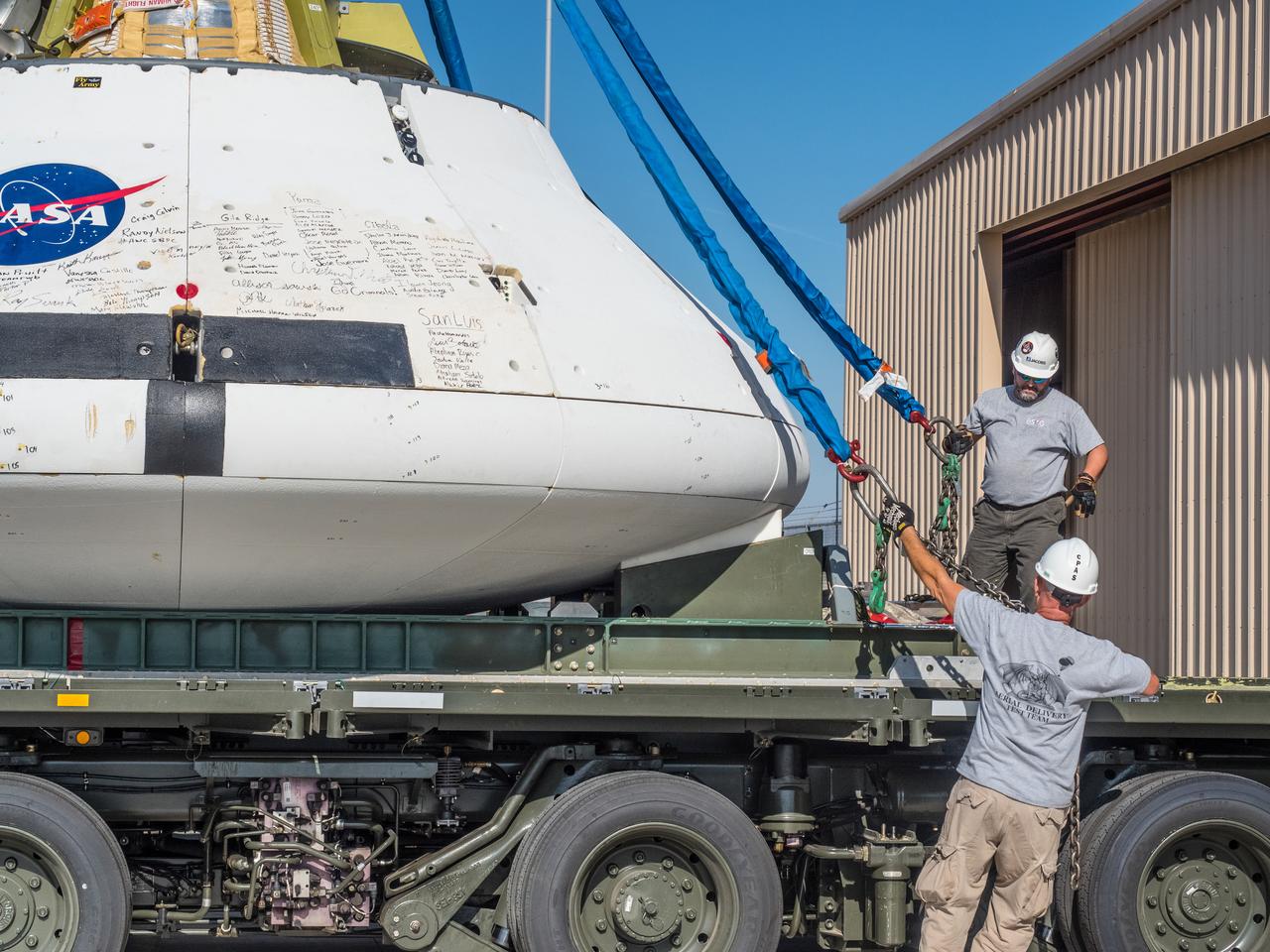 Engineers prepare to test the parachute system for NASA’s Orion spacecraft at the U.S. Army Yuma Proving Ground in Yuma, Arizona on Aug. 24, 2015. During the test, planned for Wednesday, Aug. 26, a C-17 aircraft will carry a representative Orion capsule to 35,000 feet in altitude and then drop it from its cargo bay. Engineers will test a scenario in which one of Orion’s two drogue parachutes, used to stabilize it in the air, does not deploy, and one of its three main parachutes, used to slow the capsule during the final stage of descent, also does not deploy. The risky test will provide data engineers will use as they gear up to qualify Orion’s parachutes for missions with astronauts. On Aug. 24, a C-17 was loaded with the test version of Orion, which has a similar mass and interfaces with the parachutes as the Orion being developed for deep space missions but is shorter on top to fit inside the aircraft. Part of Batch image transfer from Flickr.