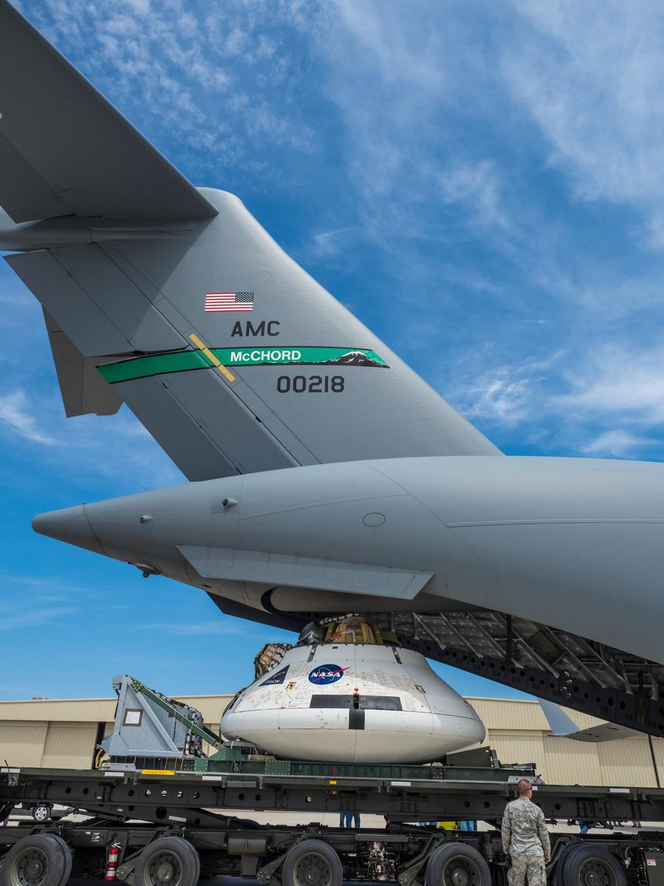 Engineers prepare to test the parachute system for NASA’s Orion spacecraft at the U.S. Army Yuma Proving Ground in Yuma, Arizona on Aug. 24, 2015. During the test, planned for Wednesday, Aug. 26, a C-17 aircraft will carry a representative Orion capsule to 35,000 feet in altitude and then drop it from its cargo bay. Engineers will test a scenario in which one of Orion’s two drogue parachutes, used to stabilize it in the air, does not deploy, and one of its three main parachutes, used to slow the capsule during the final stage of descent, also does not deploy. The risky test will provide data engineers will use as they gear up to qualify Orion’s parachutes for missions with astronauts. On Aug. 24, a C-17 was loaded with the test version of Orion, which has a similar mass and interfaces with the parachutes as the Orion being developed for deep space missions but is shorter on top to fit inside the aircraft. Part of Batch image transfer from Flickr.