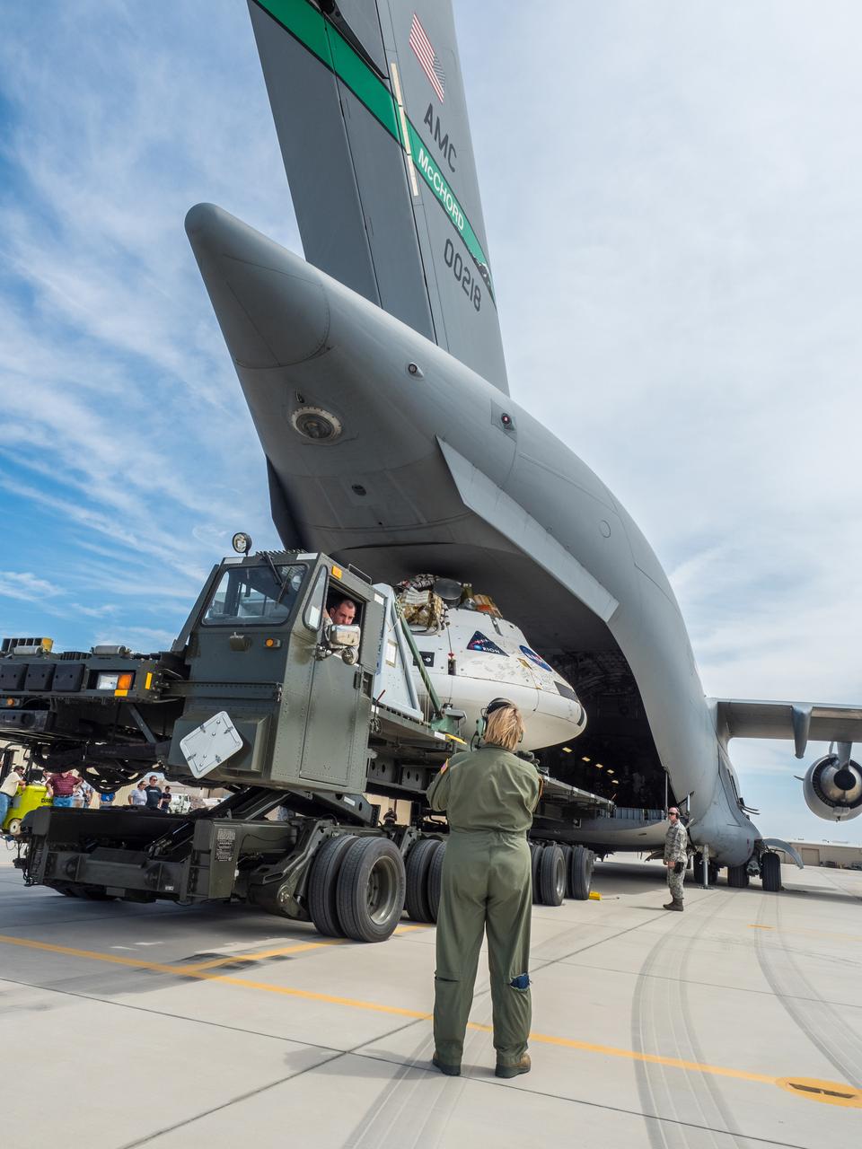 Engineers prepare to test the parachute system for NASA’s Orion spacecraft at the U.S. Army Yuma Proving Ground in Yuma, Arizona on Aug. 24, 2015. During the test, planned for Wednesday, Aug. 26, a C-17 aircraft will carry a representative Orion capsule to 35,000 feet in altitude and then drop it from its cargo bay. Engineers will test a scenario in which one of Orion’s two drogue parachutes, used to stabilize it in the air, does not deploy, and one of its three main parachutes, used to slow the capsule during the final stage of descent, also does not deploy. The risky test will provide data engineers will use as they gear up to qualify Orion’s parachutes for missions with astronauts. On Aug. 24, a C-17 was loaded with the test version of Orion, which has a similar mass and interfaces with the parachutes as the Orion being developed for deep space missions but is shorter on top to fit inside the aircraft. Part of Batch image transfer from Flickr.
