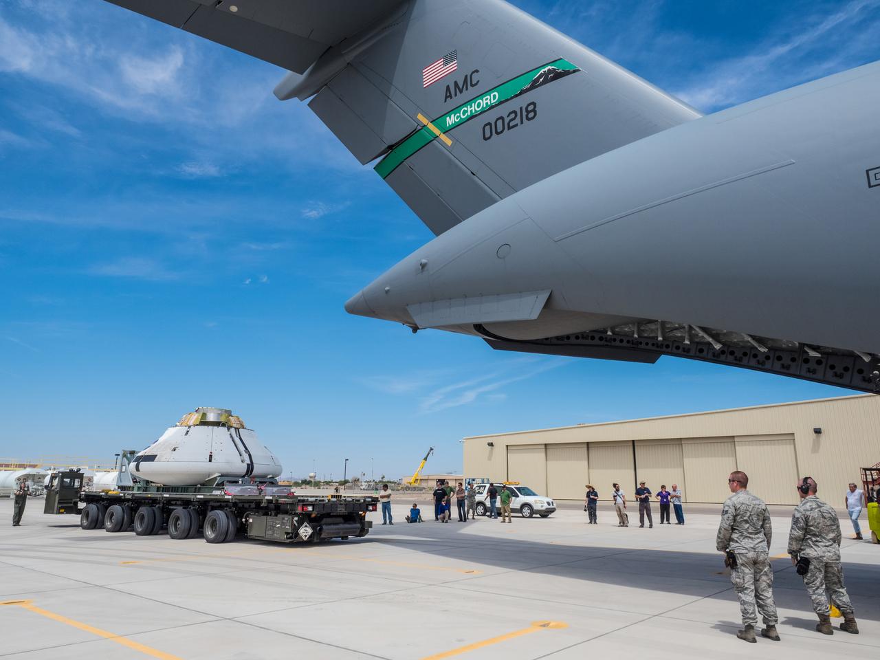 Engineers prepare to test the parachute system for NASA’s Orion spacecraft at the U.S. Army Yuma Proving Ground in Yuma, Arizona on Aug. 24, 2015. During the test, planned for Wednesday, Aug. 26, a C-17 aircraft will carry a representative Orion capsule to 35,000 feet in altitude and then drop it from its cargo bay. Engineers will test a scenario in which one of Orion’s two drogue parachutes, used to stabilize it in the air, does not deploy, and one of its three main parachutes, used to slow the capsule during the final stage of descent, also does not deploy. The risky test will provide data engineers will use as they gear up to qualify Orion’s parachutes for missions with astronauts. On Aug. 24, a C-17 was loaded with the test version of Orion, which has a similar mass and interfaces with the parachutes as the Orion being developed for deep space missions but is shorter on top to fit inside the aircraft. Part of Batch image transfer from Flickr.