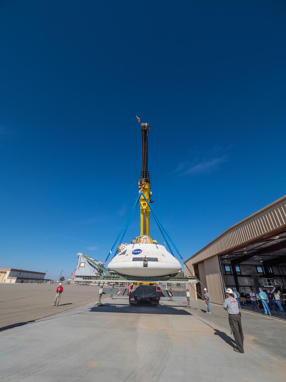 Engineers prepare to test the parachute system for NASA’s Orion spacecraft at the U.S. Army Yuma Proving Ground in Yuma, Arizona on Aug. 24, 2015. During the test, planned for Wednesday, Aug. 26, a C-17 aircraft will carry a representative Orion capsule to 35,000 feet in altitude and then drop it from its cargo bay. Engineers will test a scenario in which one of Orion’s two drogue parachutes, used to stabilize it in the air, does not deploy, and one of its three main parachutes, used to slow the capsule during the final stage of descent, also does not deploy. The risky test will provide data engineers will use as they gear up to qualify Orion’s parachutes for missions with astronauts. On Aug. 24, a C-17 was loaded with the test version of Orion, which has a similar mass and interfaces with the parachutes as the Orion being developed for deep space missions but is shorter on top to fit inside the aircraft. Part of Batch image transfer from Flickr.