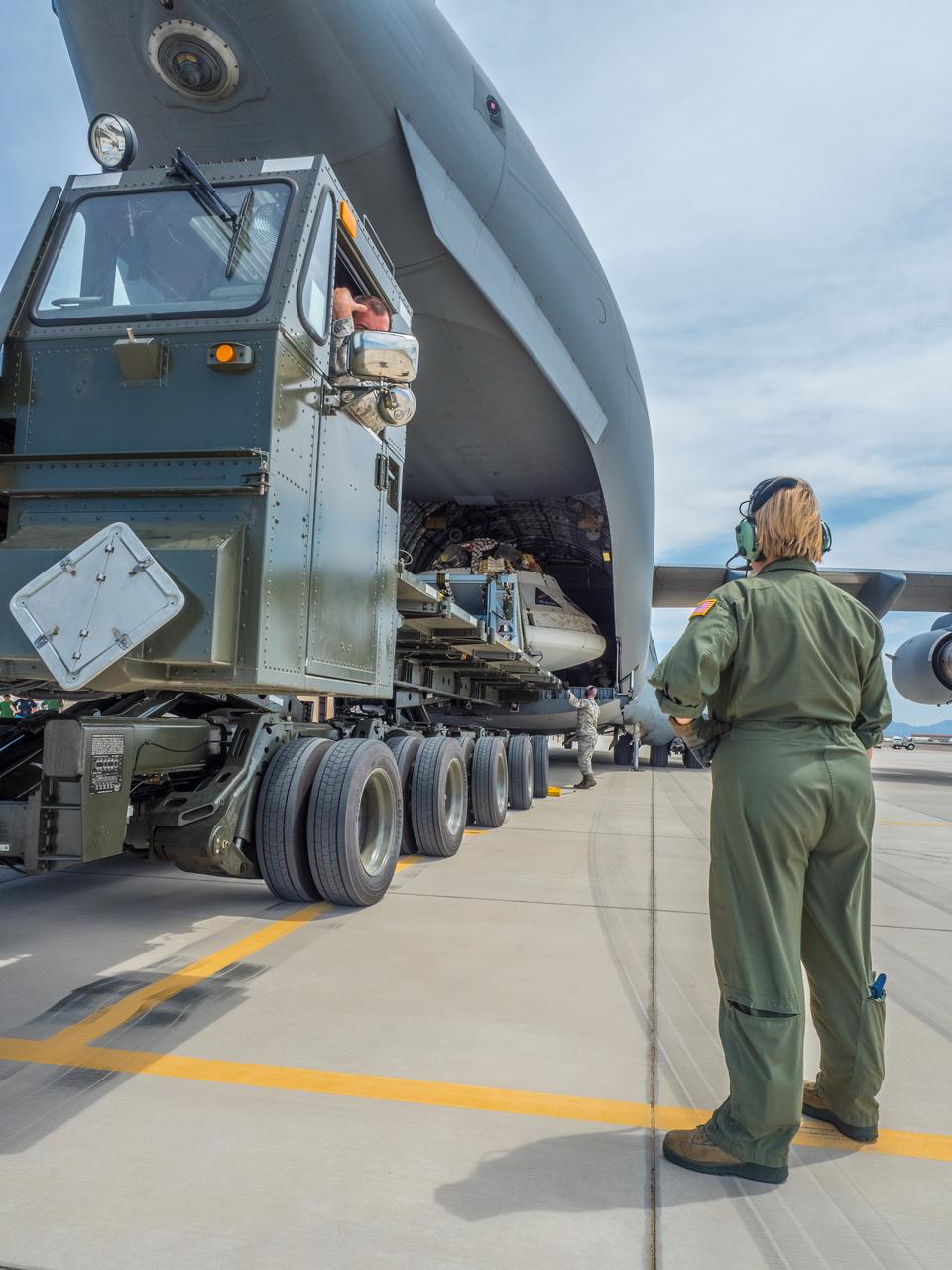 Engineers prepare to test the parachute system for NASA’s Orion spacecraft at the U.S. Army Yuma Proving Ground in Yuma, Arizona on Aug. 24, 2015. During the test, planned for Wednesday, Aug. 26, a C-17 aircraft will carry a representative Orion capsule to 35,000 feet in altitude and then drop it from its cargo bay. Engineers will test a scenario in which one of Orion’s two drogue parachutes, used to stabilize it in the air, does not deploy, and one of its three main parachutes, used to slow the capsule during the final stage of descent, also does not deploy. The risky test will provide data engineers will use as they gear up to qualify Orion’s parachutes for missions with astronauts. On Aug. 24, a C-17 was loaded with the test version of Orion, which has a similar mass and interfaces with the parachutes as the Orion being developed for deep space missions but is shorter on top to fit inside the aircraft. Part of Batch image transfer from Flickr.