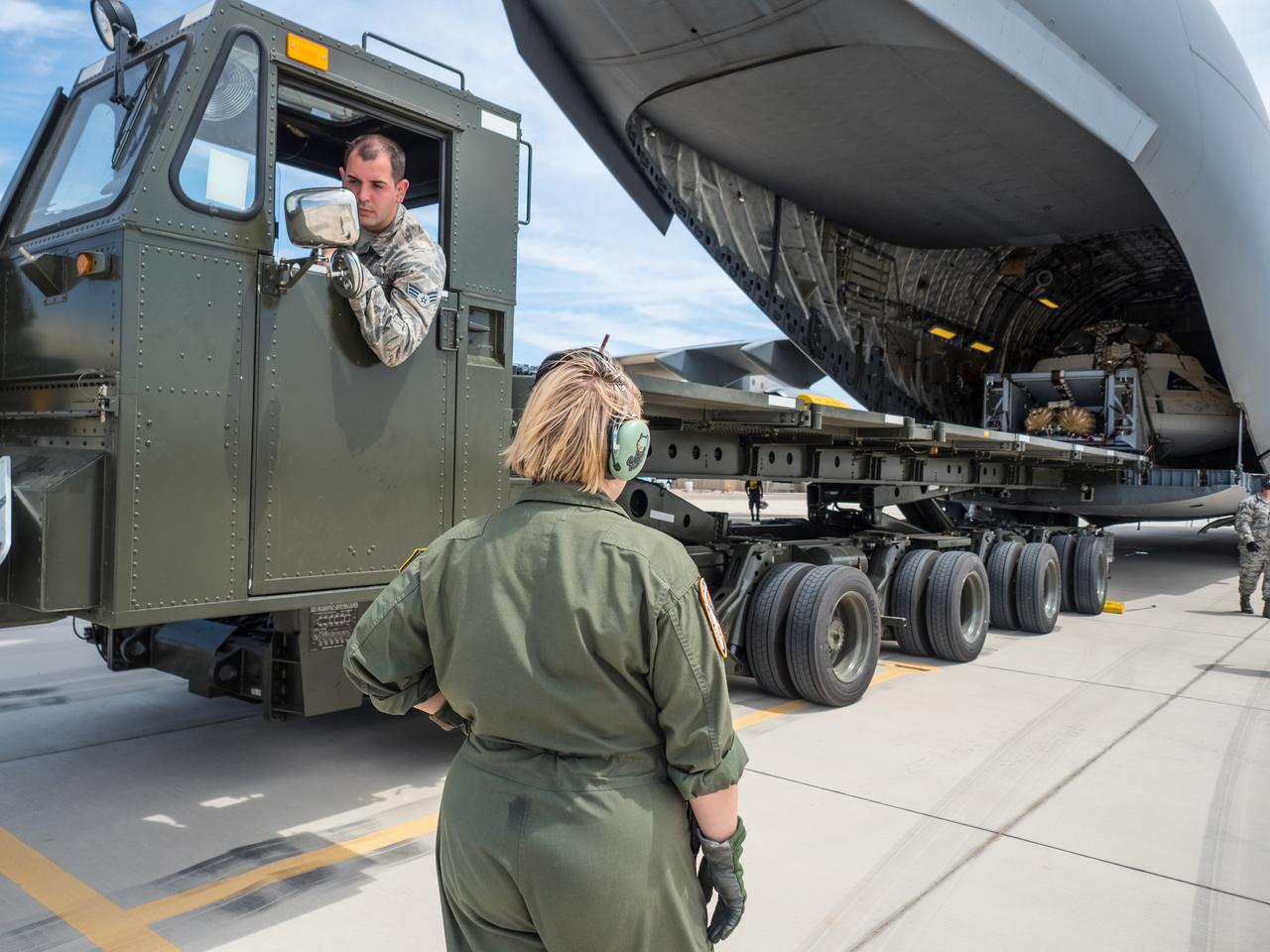 Engineers prepare to test the parachute system for NASA’s Orion spacecraft at the U.S. Army Yuma Proving Ground in Yuma, Arizona on Aug. 24, 2015. During the test, planned for Wednesday, Aug. 26, a C-17 aircraft will carry a representative Orion capsule to 35,000 feet in altitude and then drop it from its cargo bay. Engineers will test a scenario in which one of Orion’s two drogue parachutes, used to stabilize it in the air, does not deploy, and one of its three main parachutes, used to slow the capsule during the final stage of descent, also does not deploy. The risky test will provide data engineers will use as they gear up to qualify Orion’s parachutes for missions with astronauts. On Aug. 24, a C-17 was loaded with the test version of Orion, which has a similar mass and interfaces with the parachutes as the Orion being developed for deep space missions but is shorter on top to fit inside the aircraft. Part of Batch image transfer from Flickr.