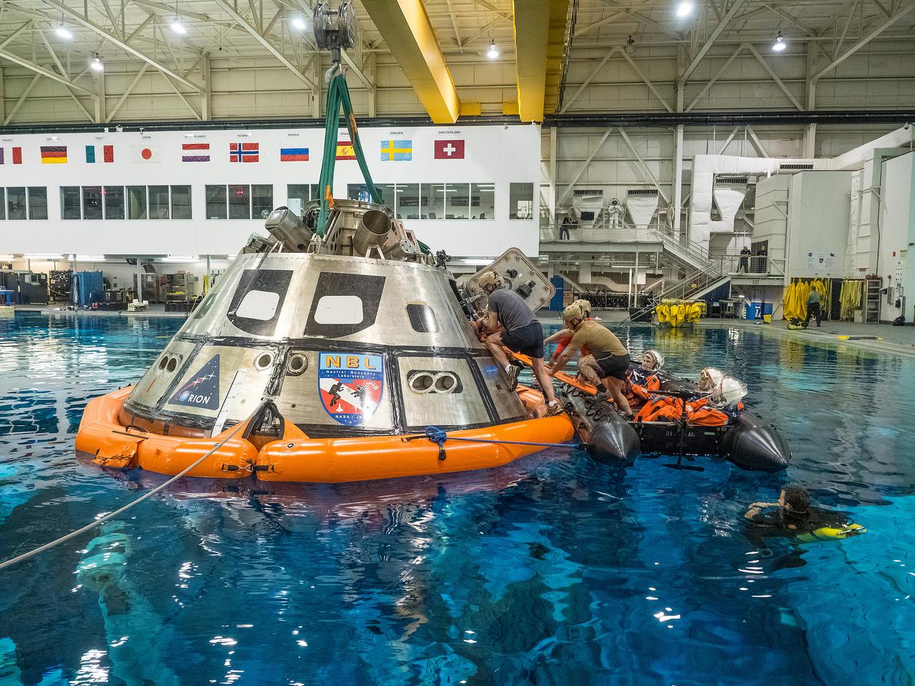 Teams perform a series of tests at NASA’s Neutral Buoyancy Laboratory (NBL) at the agency’s Johnson Space Center in Houston on Oct. 7, 2015, to evaluate the most efficient way for astronauts to get out of the Orion spacecraft after weeks or months away from Earth. Part of Batch image transfer from Flickr.
