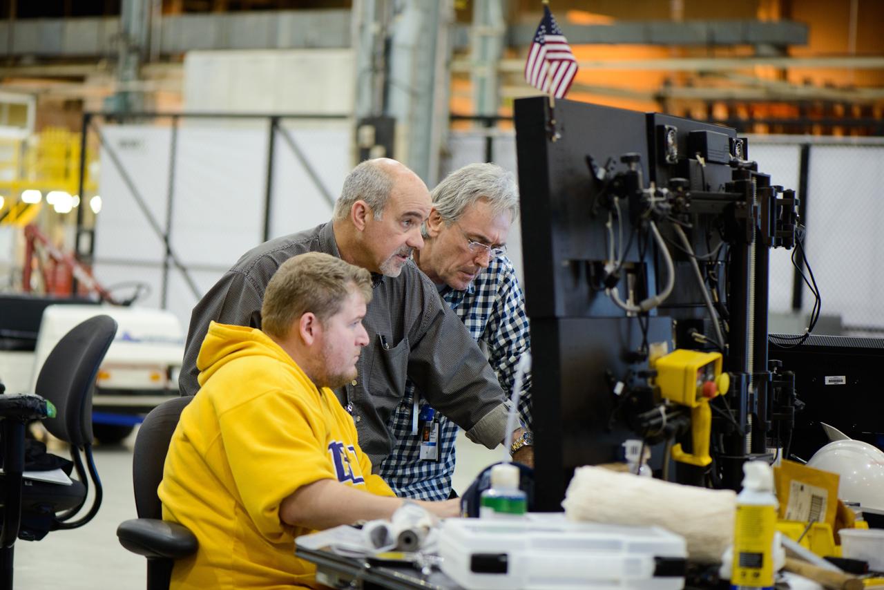 Technicians at NASA's Michoud Assembly Facility in New Orleans work on the cone weld for the Artemis I Orion crew module pressure vessel on Dec. 9, 2015.  Part of Batch image transfer from Flickr.
