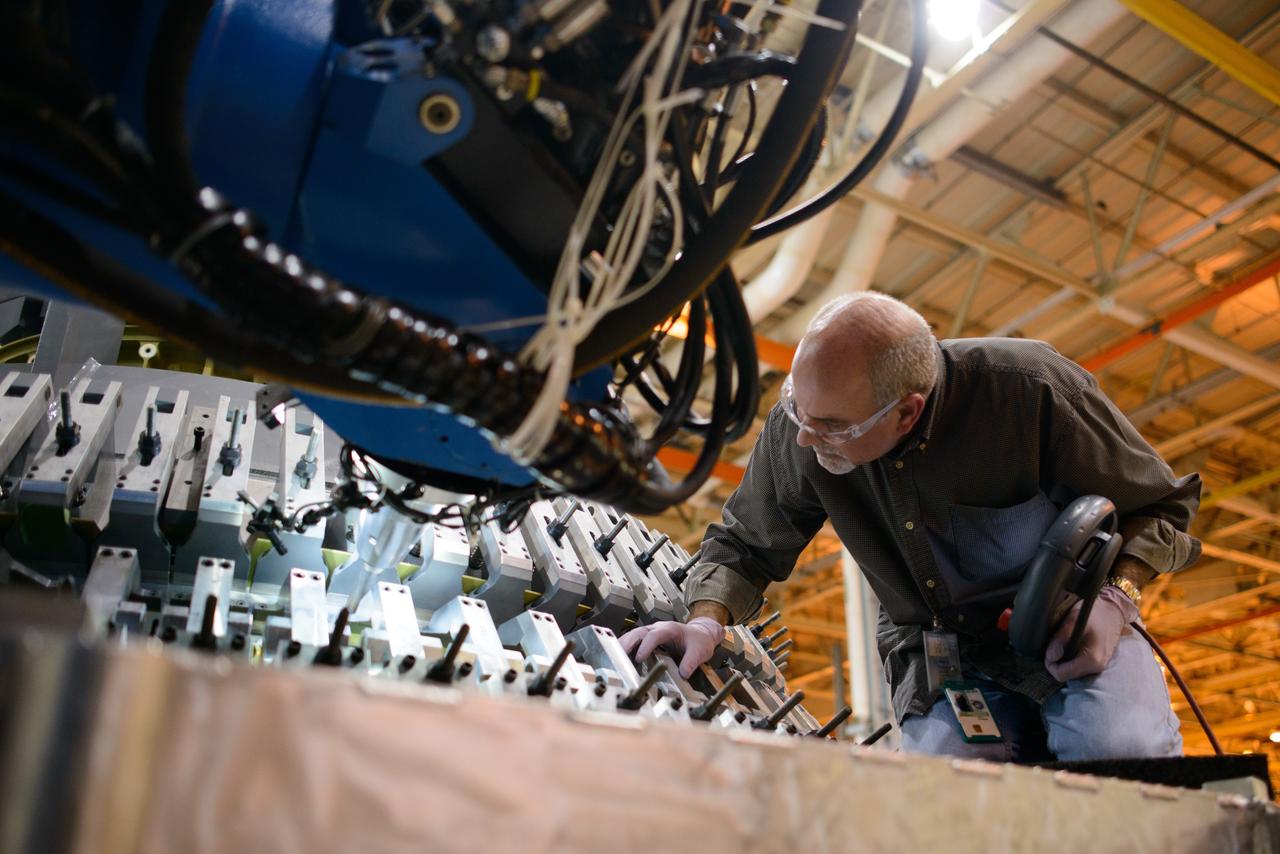 Technicians at NASA's Michoud Assembly Facility in New Orleans work on the cone weld for the Artemis I Orion crew module pressure vessel on Dec. 9, 2015.  Part of Batch image transfer from Flickr.