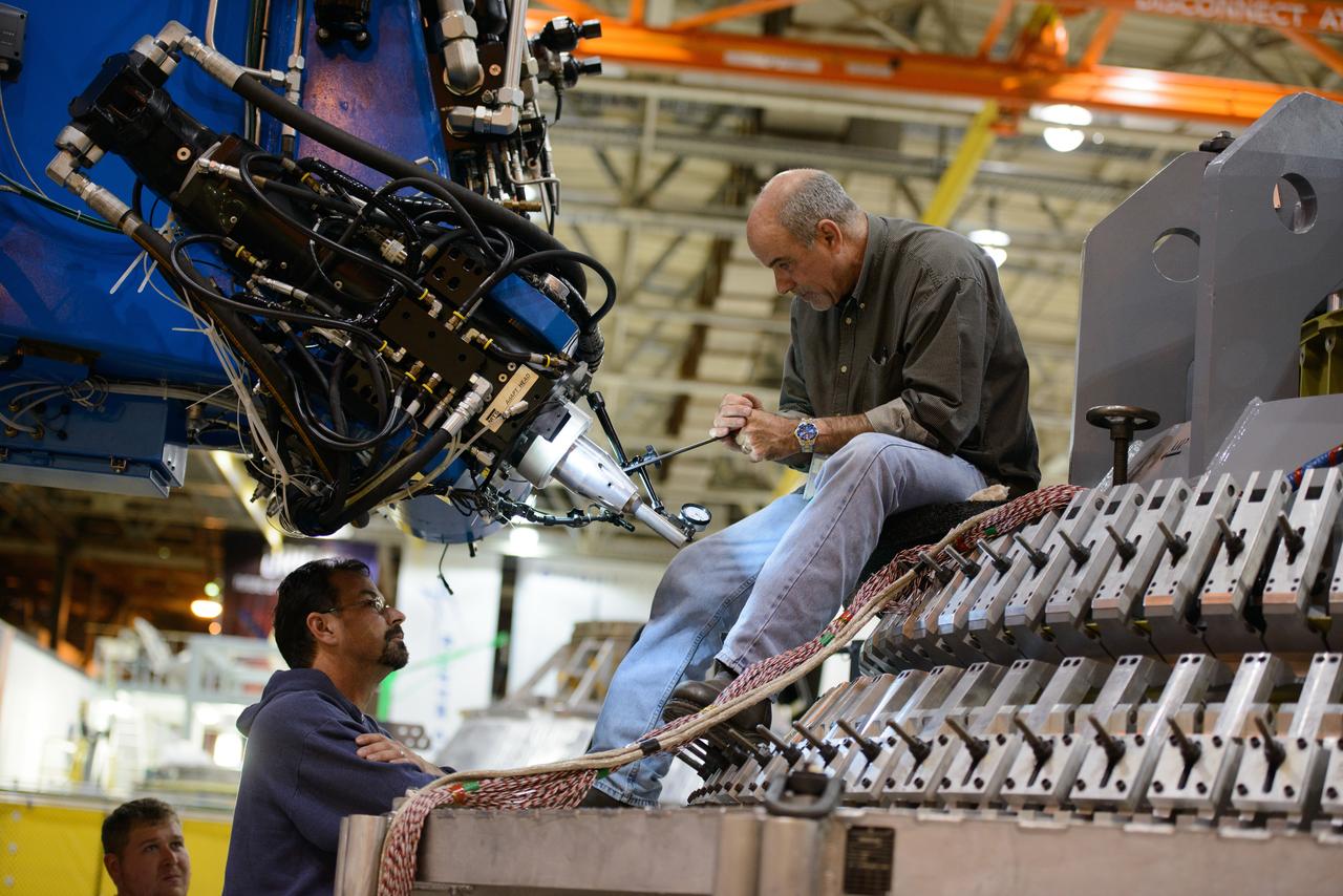 Technicians at NASA's Michoud Assembly Facility in New Orleans work on the cone weld for the Artemis I Orion crew module pressure vessel on Dec. 9, 2015.  Part of Batch image transfer from Flickr.