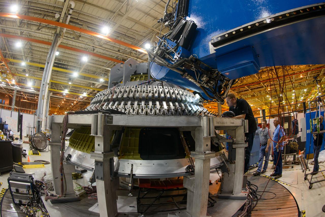 Technicians at NASA's Michoud Assembly Facility in New Orleans work on the cone weld for the Artemis I Orion crew module pressure vessel on Dec. 9, 2015.  Part of Batch image transfer from Flickr.