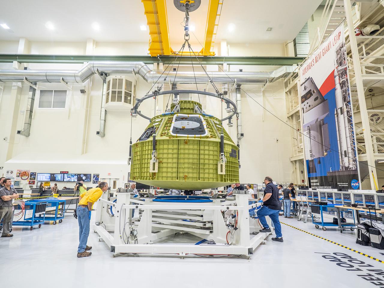 After arriving from New Orleans by Super Guppy, Artemis I Orion is moved to the work stand at the Operations and Checkout Building at NASA's Kennedy Space Center on Feb. 2, 2016.  Part of Batch image transfer from Flickr.