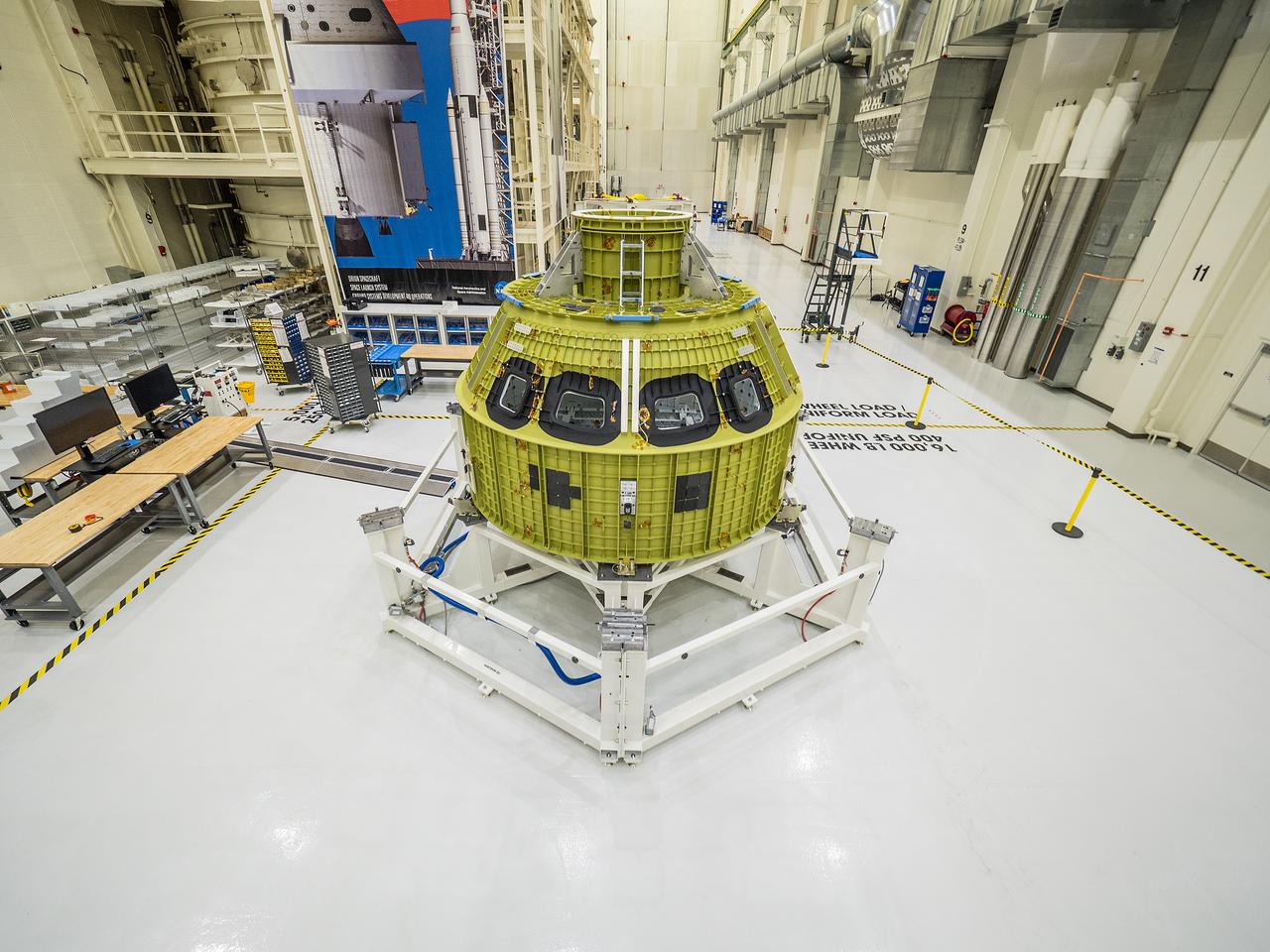 After arriving from New Orleans by Super Guppy, Artemis I Orion is moved to the work stand at the Operations and Checkout Building at NASA's Kennedy Space Center on Feb. 2, 2016.  Part of Batch image transfer from Flickr.