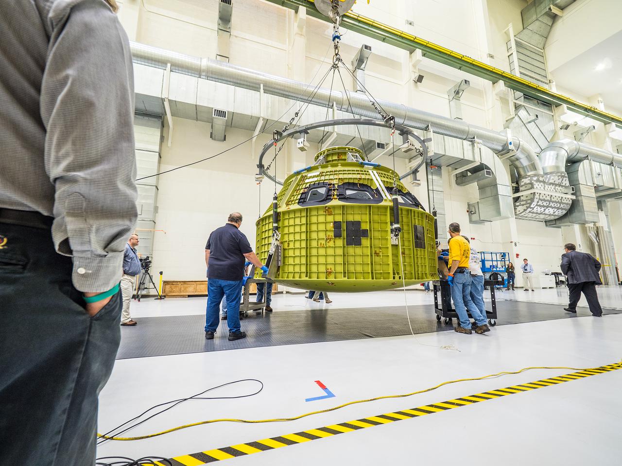 After arriving from New Orleans by Super Guppy, Artemis I Orion is moved to the work stand at the Operations and Checkout Building at NASA's Kennedy Space Center on Feb. 2, 2016. Part of Batch image transfer from Flickr.
