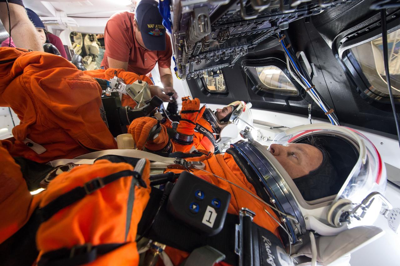 Engineers at NASA's Johnson Space Center in Houston evaluate how crews inside a mockup of the Orion spacecraft interact with the rotational hand controller and cursor control device while inside their Modified Advanced Crew Escape spacesuits on March 24, 2016. The controllers are used to operate Orion’s displays and control system, which the crew will use to maneuver and interact with the spacecraft during missions to deep space destinations. The testing aims to provide data that teams need to make sure astronauts who ride to space in Orion can appropriately interact with the control system while in their suits.
