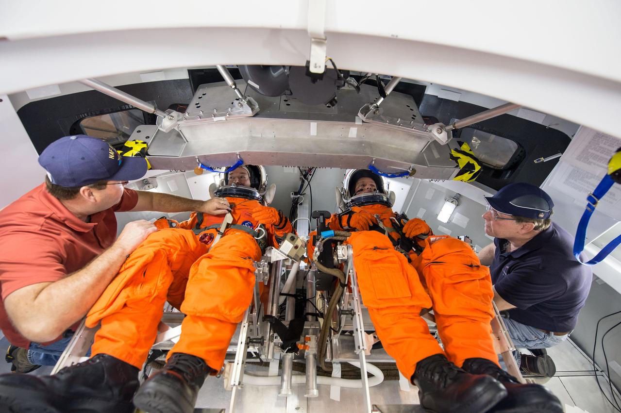 Engineers at NASA's Johnson Space Center in Houston evaluate how crews inside a mockup of the Orion spacecraft interact with the rotational hand controller and cursor control device while inside their Modified Advanced Crew Escape spacesuits on March 24, 2016. The controllers are used to operate Orion’s displays and control system, which the crew will use to maneuver and interact with the spacecraft during missions to deep space destinations. The testing aims to provide data that teams need to make sure astronauts who ride to space in Orion can appropriately interact with the control system while in their suits.