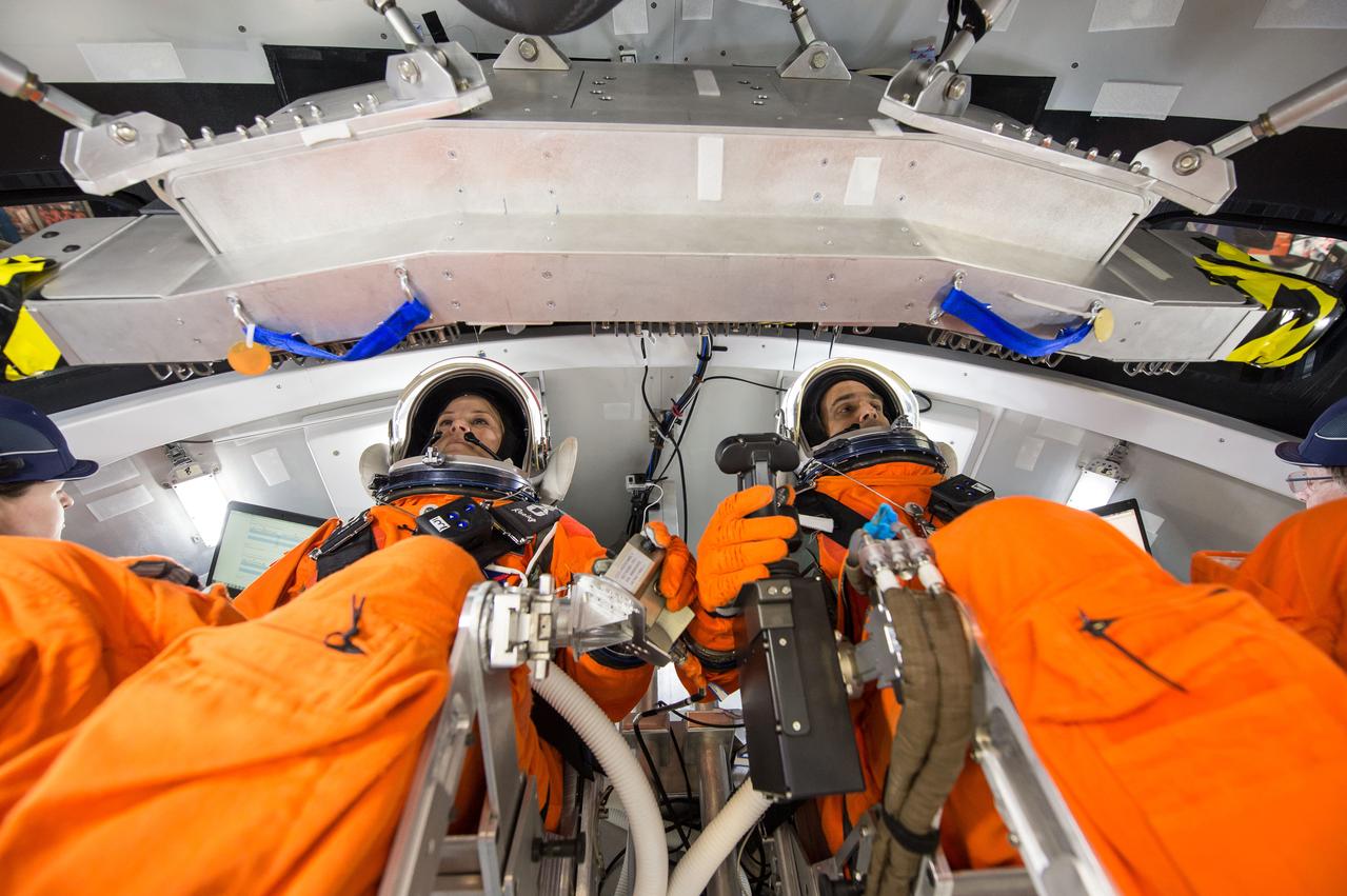 Engineers at NASA's Johnson Space Center in Houston evaluate how crews inside a mockup of the Orion spacecraft interact with the rotational hand controller and cursor control device while inside their Modified Advanced Crew Escape spacesuits on March 24, 2016. The controllers are used to operate Orion’s displays and control system, which the crew will use to maneuver and interact with the spacecraft during missions to deep space destinations. The testing aims to provide data that teams need to make sure astronauts who ride to space in Orion can appropriately interact with the control system while in their suits.
