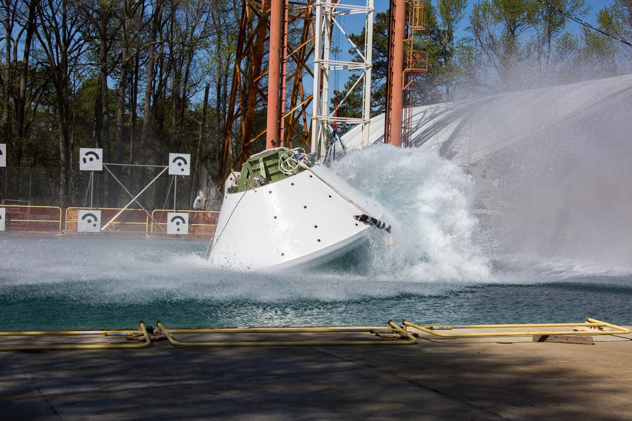 On April 6, 2016, engineers at NASA’s Langley Research Center in Hampton, Virginia, kicked off a series of nine drop tests of a representative Orion crew capsule with crash test dummies inside to understand what the spacecraft and astronauts may experience when landing in the Pacific Ocean after deep-space missions. The high-fidelity capsule, coupled with the heat shield from Orion's first flight in space, was hoisted approximately 16 feet above the water and vertically dropped into Langley’s 20-foot-deep Hydro Impact Basin. The crash test dummies were instrumented to provide data and secured inside the capsule to help provide information engineers need to ensure astronauts will be protected from injury during splashdown. Each test in the series simulates different scenarios for Orion’s parachute-assisted landings, wind conditions, velocities and wave heights the spacecraft may experience when touching down in the ocean.