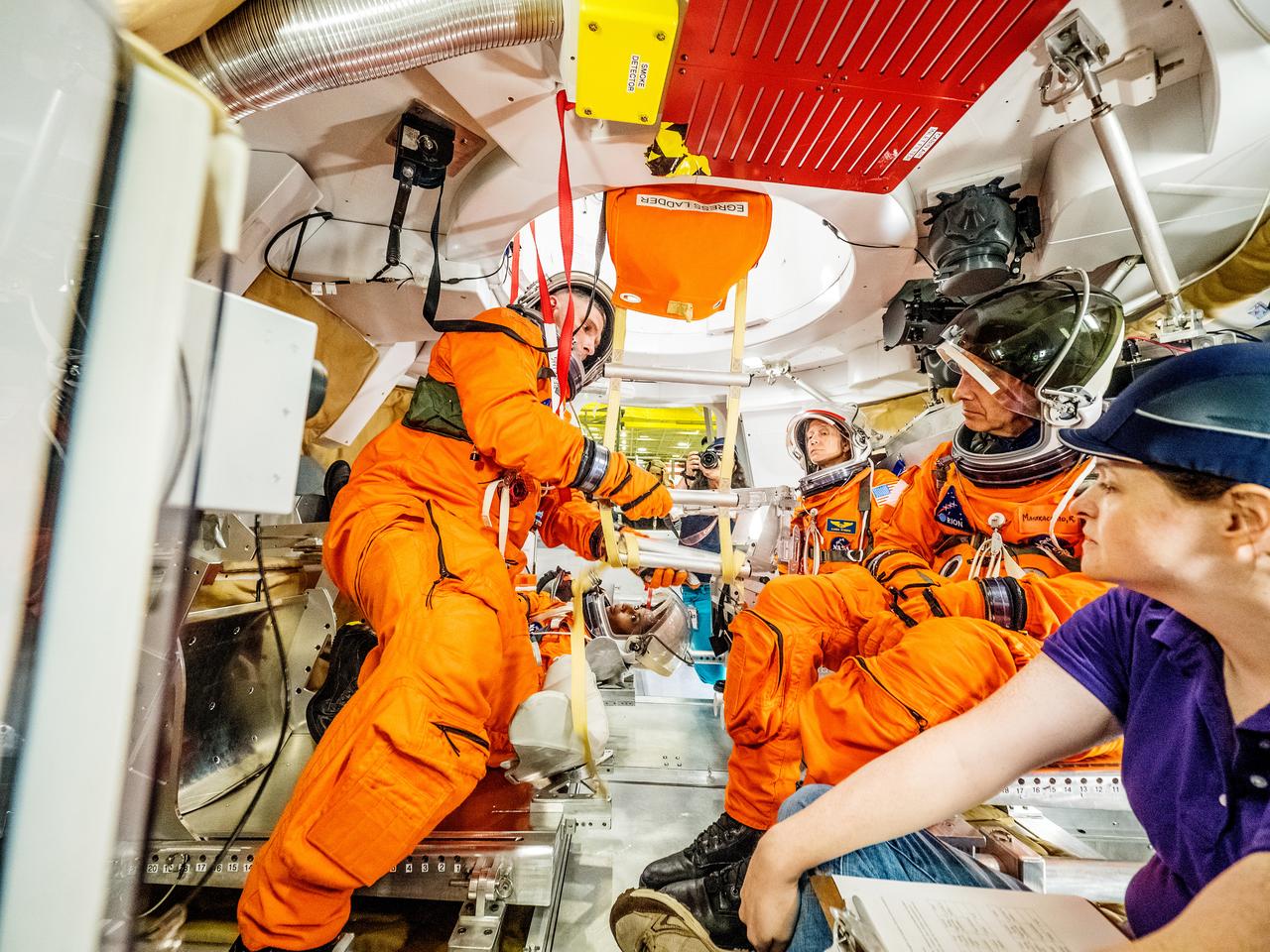 Engineers and astronauts conduct testing in a representative model of the Orion spacecraft at NASA’s Johnson Space Center in Houston on July 28, 2016 to gather the crew's feedback on the design of the docking hatch and on post-landing equipment operations. ..While the crew will primarily use the side hatch for entry and exit on Earth and the docking hatch to travel between Orion and a habitation module on long-duration deep space missions, the crew will need to be able to exit out of the docking hatch if wave heights in the Pacific Ocean upon splashdown are too high. The work is being done to help ensure all elements of Orion's design are safe and effective for the crew to use on future missions on the journey to Mars.