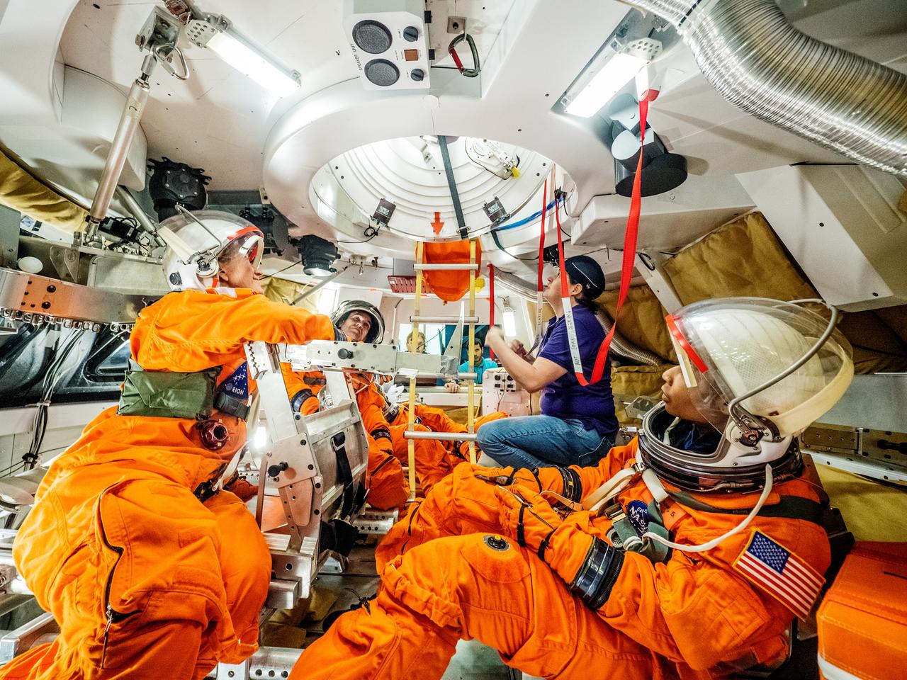 Engineers and astronauts conduct testing in a representative model of the Orion spacecraft at NASA’s Johnson Space Center in Houston on July 28, 2016 to gather the crew's feedback on the design of the docking hatch and on post-landing equipment operations. ..While the crew will primarily use the side hatch for entry and exit on Earth and the docking hatch to travel between Orion and a habitation module on long-duration deep space missions, the crew will need to be able to exit out of the docking hatch if wave heights in the Pacific Ocean upon splashdown are too high. The work is being done to help ensure all elements of Orion's design are safe and effective for the crew to use on future missions on the journey to Mars.