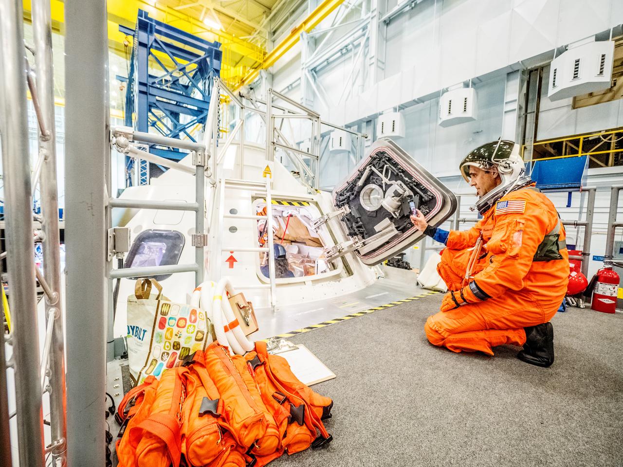 Engineers and astronauts conduct testing in a representative model of the Orion spacecraft at NASA’s Johnson Space Center in Houston on July 28, 2016 to gather the crew's feedback on the design of the docking hatch and on post-landing equipment operations. ..While the crew will primarily use the side hatch for entry and exit on Earth and the docking hatch to travel between Orion and a habitation module on long-duration deep space missions, the crew will need to be able to exit out of the docking hatch if wave heights in the Pacific Ocean upon splashdown are too high. The work is being done to help ensure all elements of Orion's design are safe and effective for the crew to use on future missions on the journey to Mars.