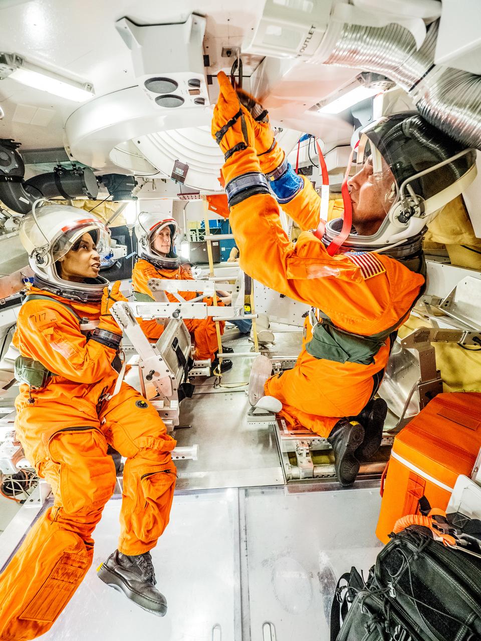 Engineers and astronauts conduct testing in a representative model of the Orion spacecraft at NASA’s Johnson Space Center in Houston on July 28, 2016 to gather the crew's feedback on the design of the docking hatch and on post-landing equipment operations. While the crew will primarily use the side hatch for entry and exit on Earth and the docking hatch to travel between Orion and a habitation module on long-duration deep space missions, the crew will need to be able to exit out of the docking hatch if wave heights in the Pacific Ocean upon splashdown are too high. The work is being done to help ensure all elements of Orion's design are safe and effective for the crew to use on future missions on the journey to Mars. Image Credit: NASA / Radislav Sinyak