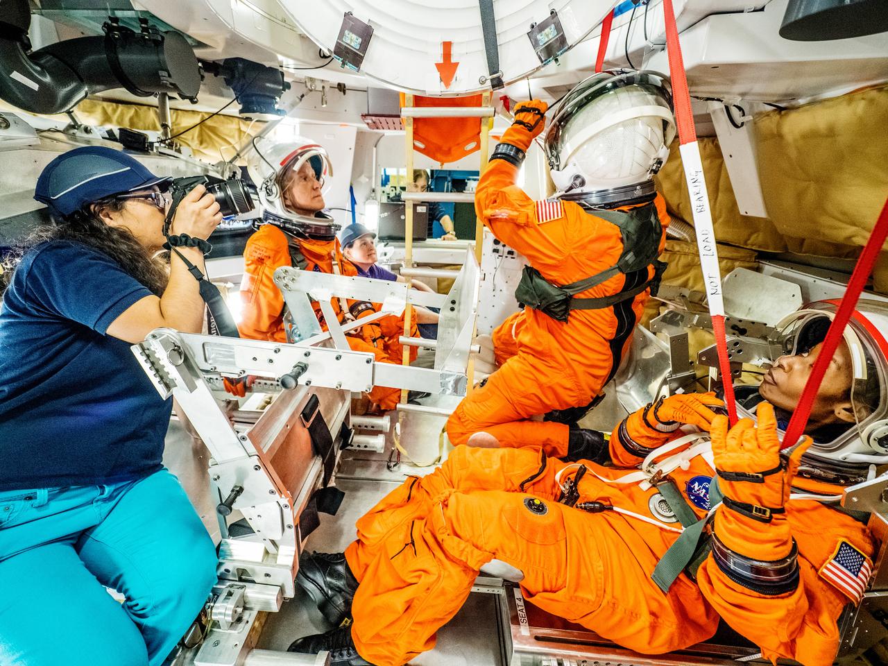 Engineers and astronauts conduct testing in a representative model of the Orion spacecraft at NASA’s Johnson Space Center in Houston on July 28, 2016 to gather the crew's feedback on the design of the docking hatch and on post-landing equipment operations. ..While the crew will primarily use the side hatch for entry and exit on Earth and the docking hatch to travel between Orion and a habitation module on long-duration deep space missions, the crew will need to be able to exit out of the docking hatch if wave heights in the Pacific Ocean upon splashdown are too high. The work is being done to help ensure all elements of Orion's design are safe and effective for the crew to use on future missions on the journey to Mars.