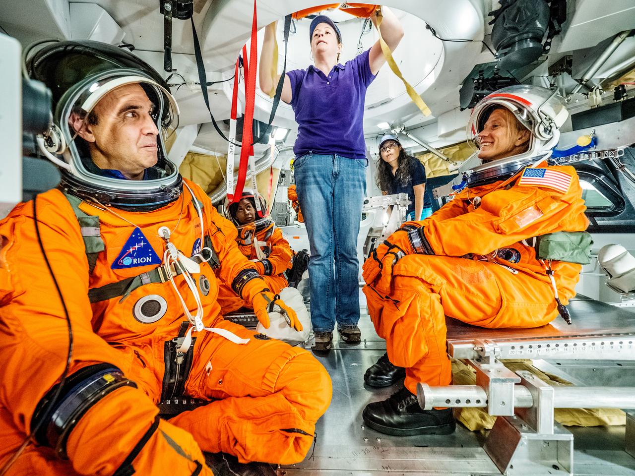 Engineers and astronauts conduct testing in a representative model of the Orion spacecraft at NASA’s Johnson Space Center in Houston on July 28, 2016 to gather the crew's feedback on the design of the docking hatch and on post-landing equipment operations. ..While the crew will primarily use the side hatch for entry and exit on Earth and the docking hatch to travel between Orion and a habitation module on long-duration deep space missions, the crew will need to be able to exit out of the docking hatch if wave heights in the Pacific Ocean upon splashdown are too high. The work is being done to help ensure all elements of Orion's design are safe and effective for the crew to use on future missions on the journey to Mars.