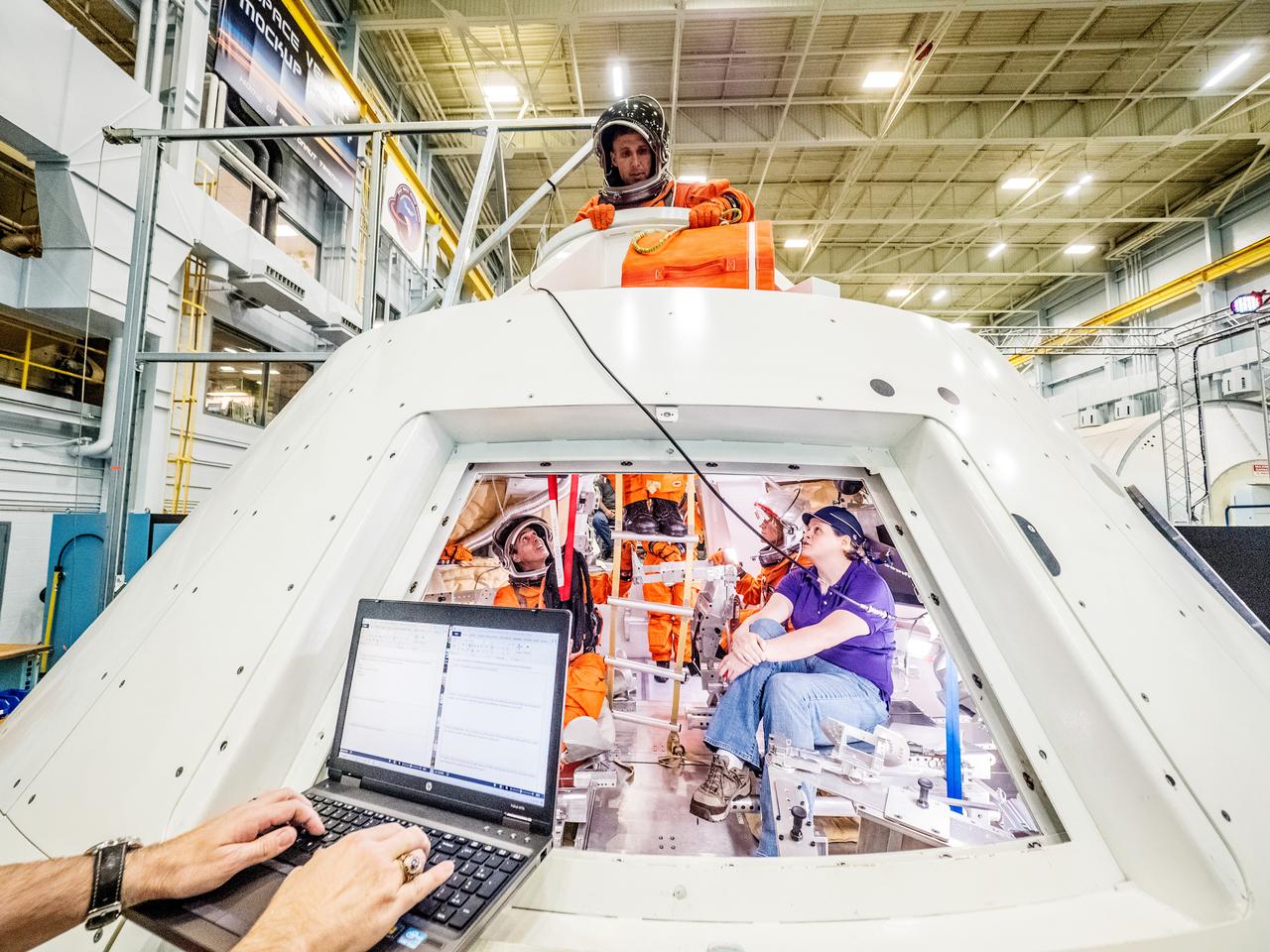 Engineers and astronauts conduct testing in a representative model of the Orion spacecraft at NASA’s Johnson Space Center in Houston on July 28, 2016 to gather the crew's feedback on the design of the docking hatch and on post-landing equipment operations. ..While the crew will primarily use the side hatch for entry and exit on Earth and the docking hatch to travel between Orion and a habitation module on long-duration deep space missions, the crew will need to be able to exit out of the docking hatch if wave heights in the Pacific Ocean upon splashdown are too high. The work is being done to help ensure all elements of Orion's design are safe and effective for the crew to use on future missions on the journey to Mars.