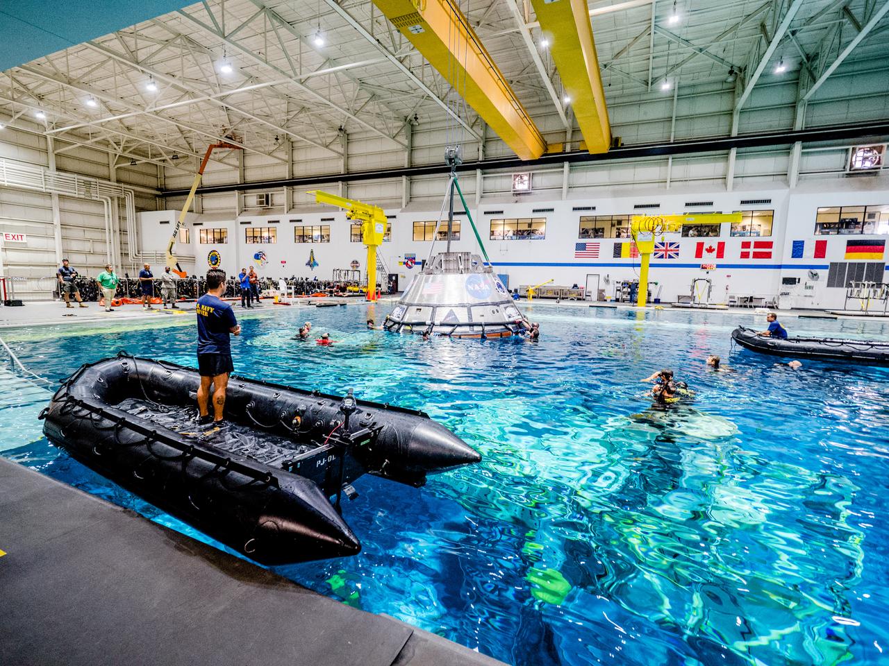 A group of U.S. Navy divers, Air Force pararescumen and Coast Guard rescue swimmers practice Orion underway recovery techniques this week in the Neutral Buoyancy Laboratory (NBL) at NASA’s Johnson Space Center in Houston on Sept. 21, 2016, to prepare for the first test flight of an uncrewed Orion spacecraft with the agency’s Space Launch System rocket during Artemis I.Part of Batch image transfer from Flickr.