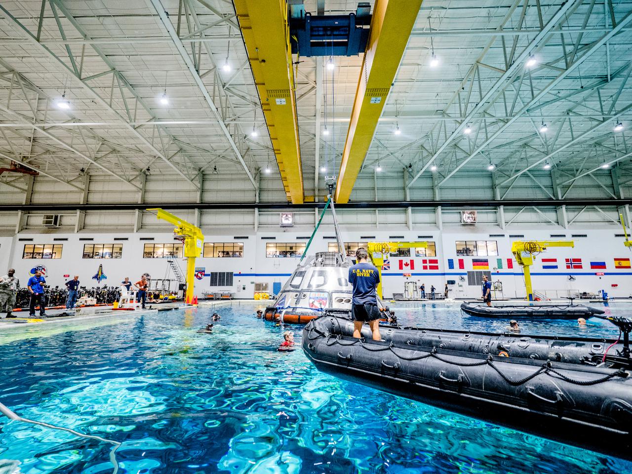 A group of U.S. Navy divers, Air Force pararescumen and Coast Guard rescue swimmers practice Orion underway recovery techniques this week in the Neutral Buoyancy Laboratory (NBL) at NASA’s Johnson Space Center in Houston on Sept. 21, 2016, to prepare for the first test flight of an uncrewed Orion spacecraft with the agency’s Space Launch System rocket during Artemis I. Part of Batch images transfer from Flickr.