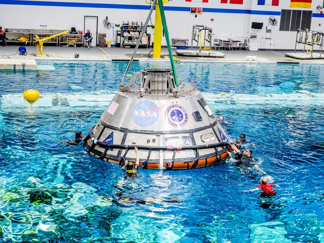 A group of U.S. Navy divers, Air Force pararescumen and Coast Guard rescue swimmers practice Orion underway recovery techniques this week in the Neutral Buoyancy Laboratory (NBL) at NASA’s Johnson Space Center in Houston on Sept. 21, 2016, to prepare for the first test flight of an uncrewed Orion spacecraft with the agency’s Space Launch System rocket during Artemis I. Part of Batch images transfer from Flickr.