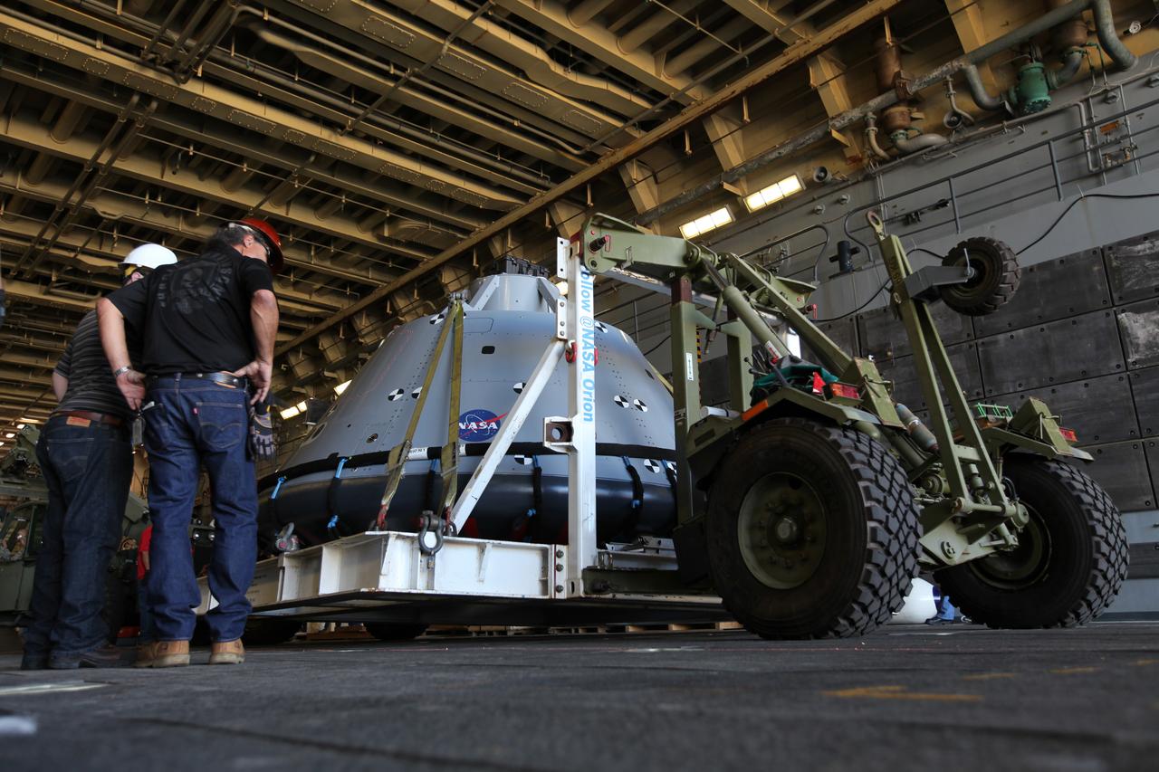 The test version of the Orion crew module is transported into the well deck of the USS San Diego at Naval Base San Diego in California on Oct. 21, 2016. NASA, Orion manufacturer Lockheed Martin and the U.S. Navy will head out to sea with the Orion test spacecraft aboard for Underway Recovery Test 5 (URT-5) in the Pacific Ocean off the coast of California. During URT-5, the team will demonstrate and evaluate the recovery processes, procedures, hardware and personnel necessary for recovery of Orion on its return from a deep space mission.
