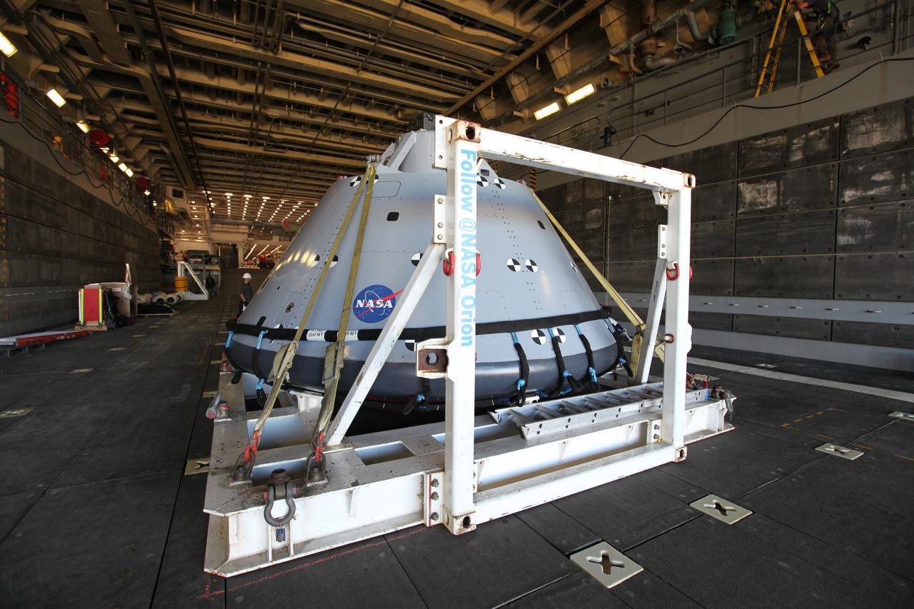 The test version of the Orion crew module is transported into the well deck of the USS San Diego at Naval Base San Diego in California on Oct. 21, 2016. NASA, Orion manufacturer Lockheed Martin and the U.S. Navy will head out to sea with the Orion test spacecraft aboard for Underway Recovery Test 5 (URT-5) in the Pacific Ocean off the coast of California. During URT-5, the team will demonstrate and evaluate the recovery processes, procedures, hardware and personnel necessary for recovery of Orion on its return from a deep space mission.