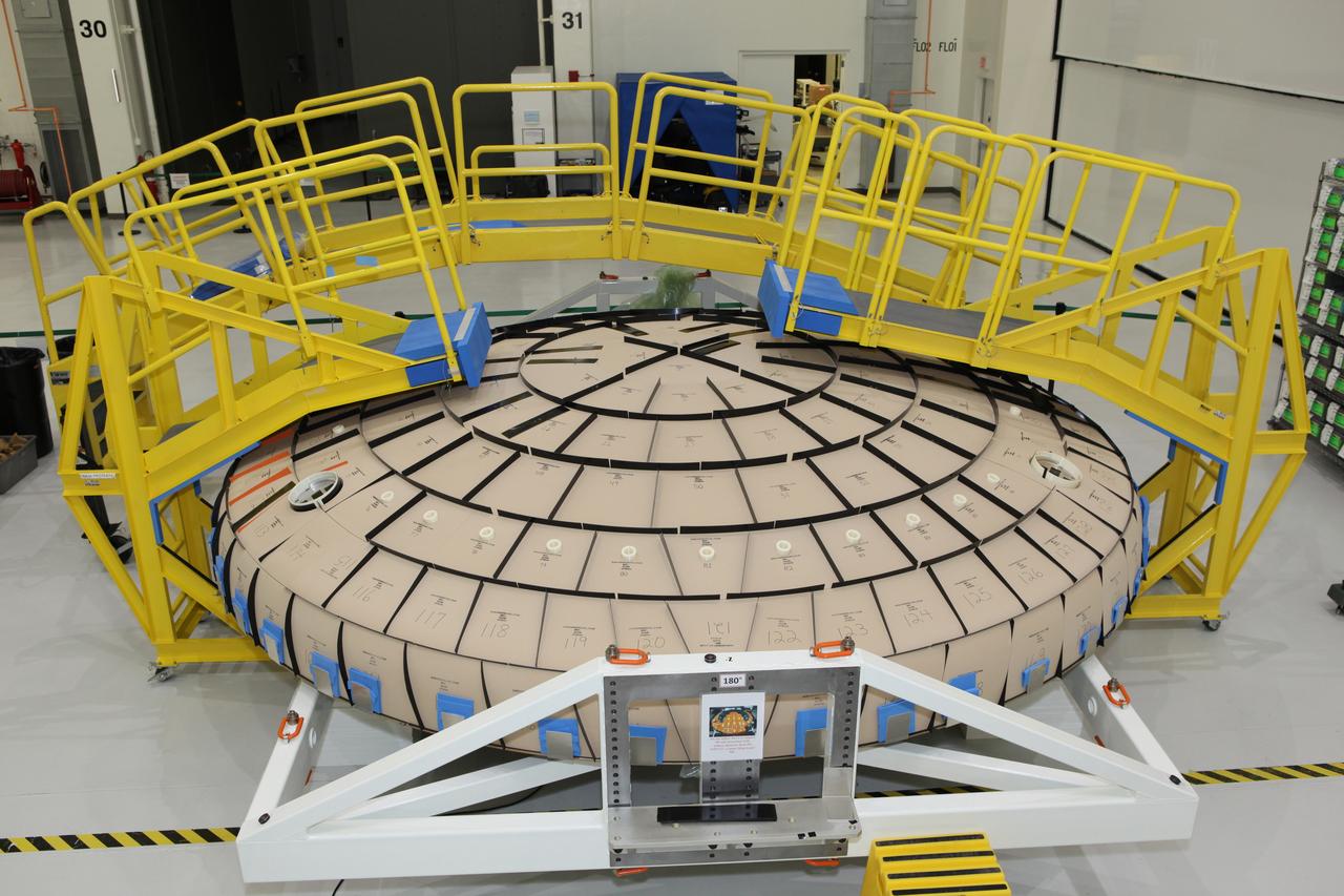 Tile blocks are prefitted around the heat shield for the Orion crew module inside the Neil Armstrong Operations and Checkout Building high bay at NASA’s Kennedy Space Center in Florida on Oct. 24, 2016. Part of Batch images transfer from Flickr. 