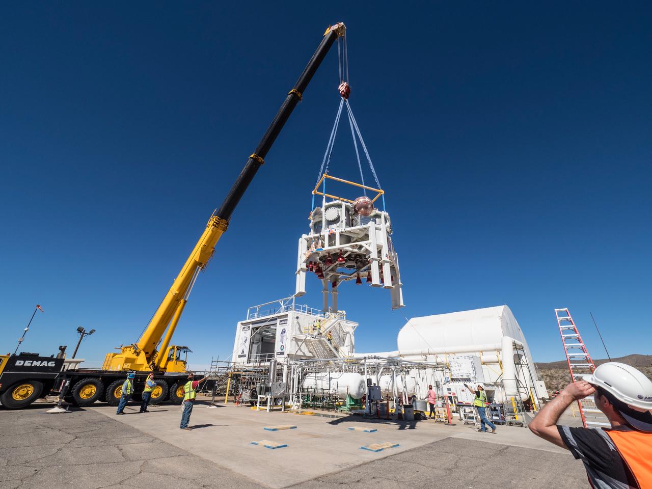 On Feb. 22, engineers successfully install ESA’s European Service Module Propulsion Qualification Module (PQM) at NASA’s White Sands Test Facility in New Mexico that was delivered by Airbus – ESA’s prime contractor for the Service Module. The module will be equipped with a total of 21 engines to support NASA’s Orion spacecraft: one U.S. Space Shuttle Orbital Maneuvering System (OMS) engine, eight auxiliary thrusters and 12 smaller thrusters produced by Airbus Safran Launchers in Germany. The all-steel PQM structure is used to test the propulsion systems on Orion, including “hot firing” of the OMS engine and thrusters.